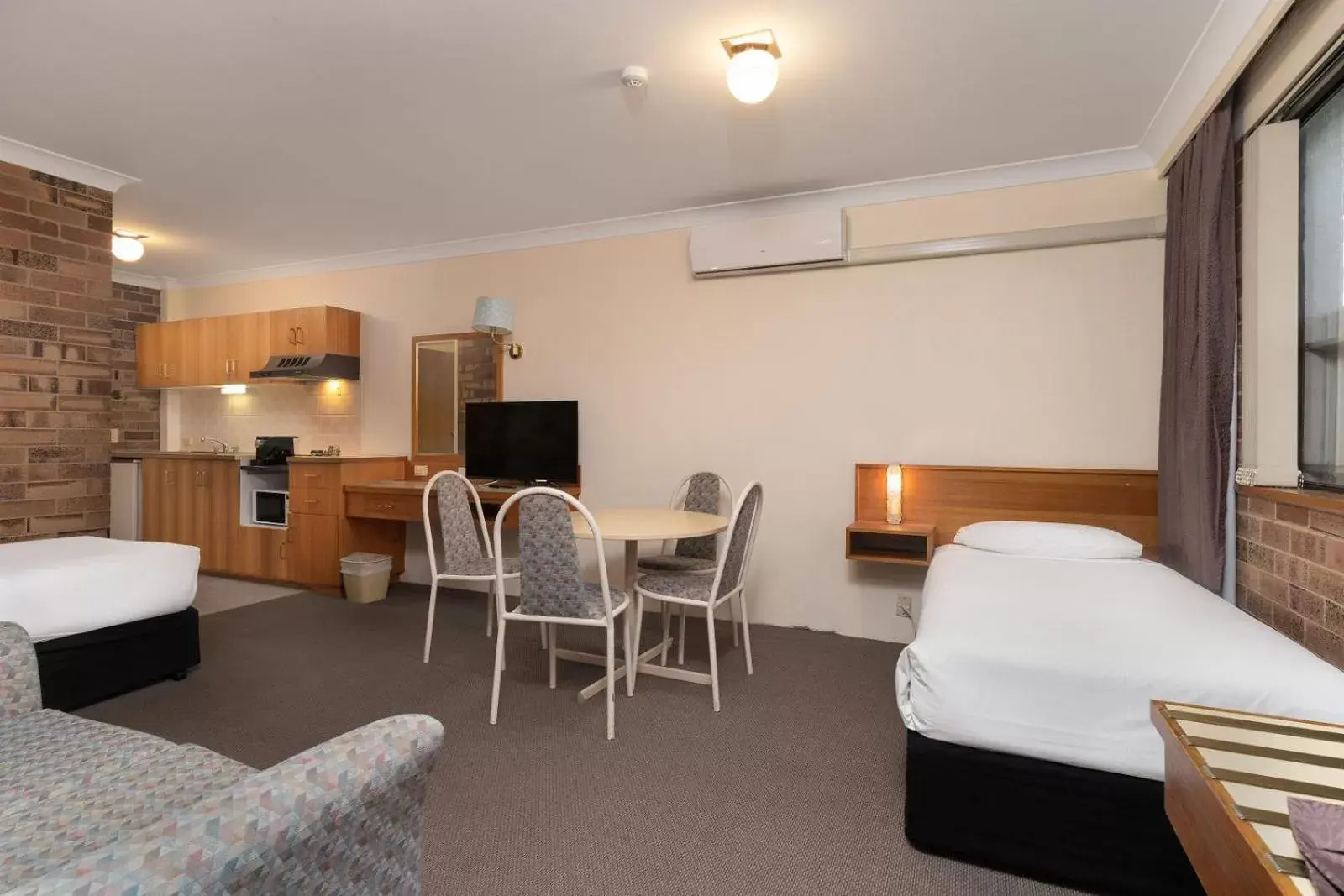 Bedroom, Seating Area in All Seasons Motel Armidale