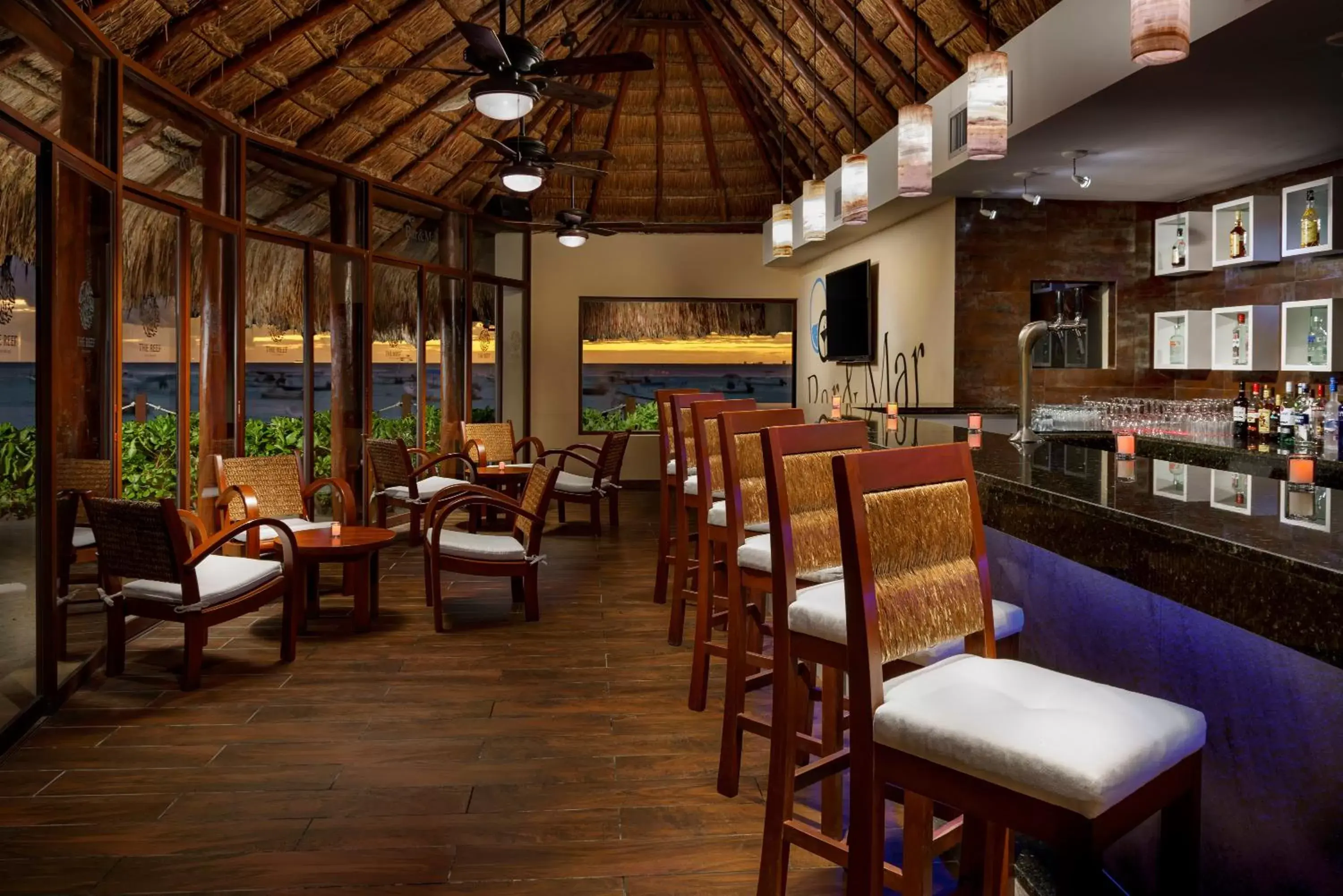 Lounge or bar in The Reef Coco Beach Resort & Spa- Optional All Inclusive Lounge or bar in The Reef Coco Beach Resort & Spa- Optional All Inclusive