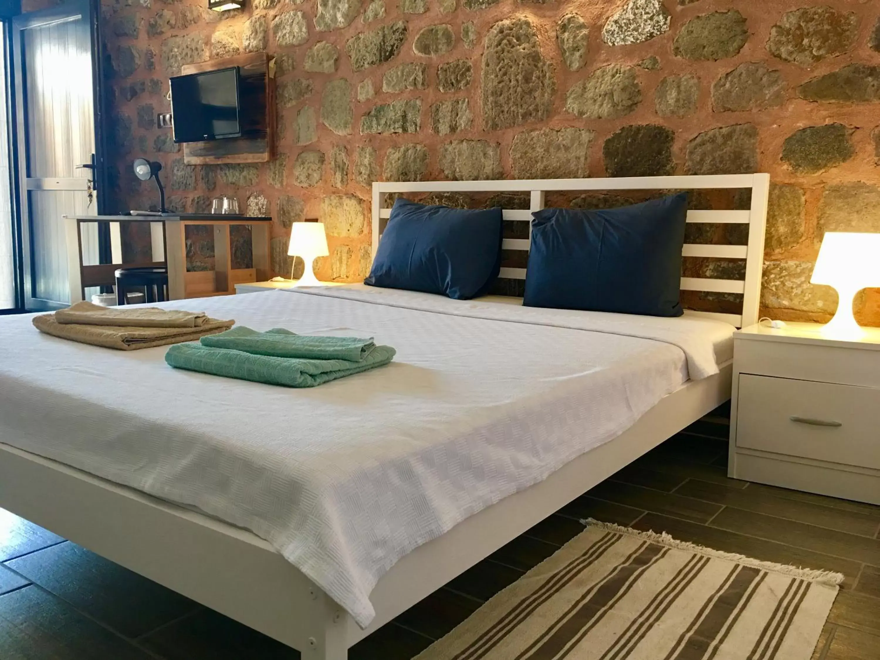 Bed in Attalos Suites Hotel