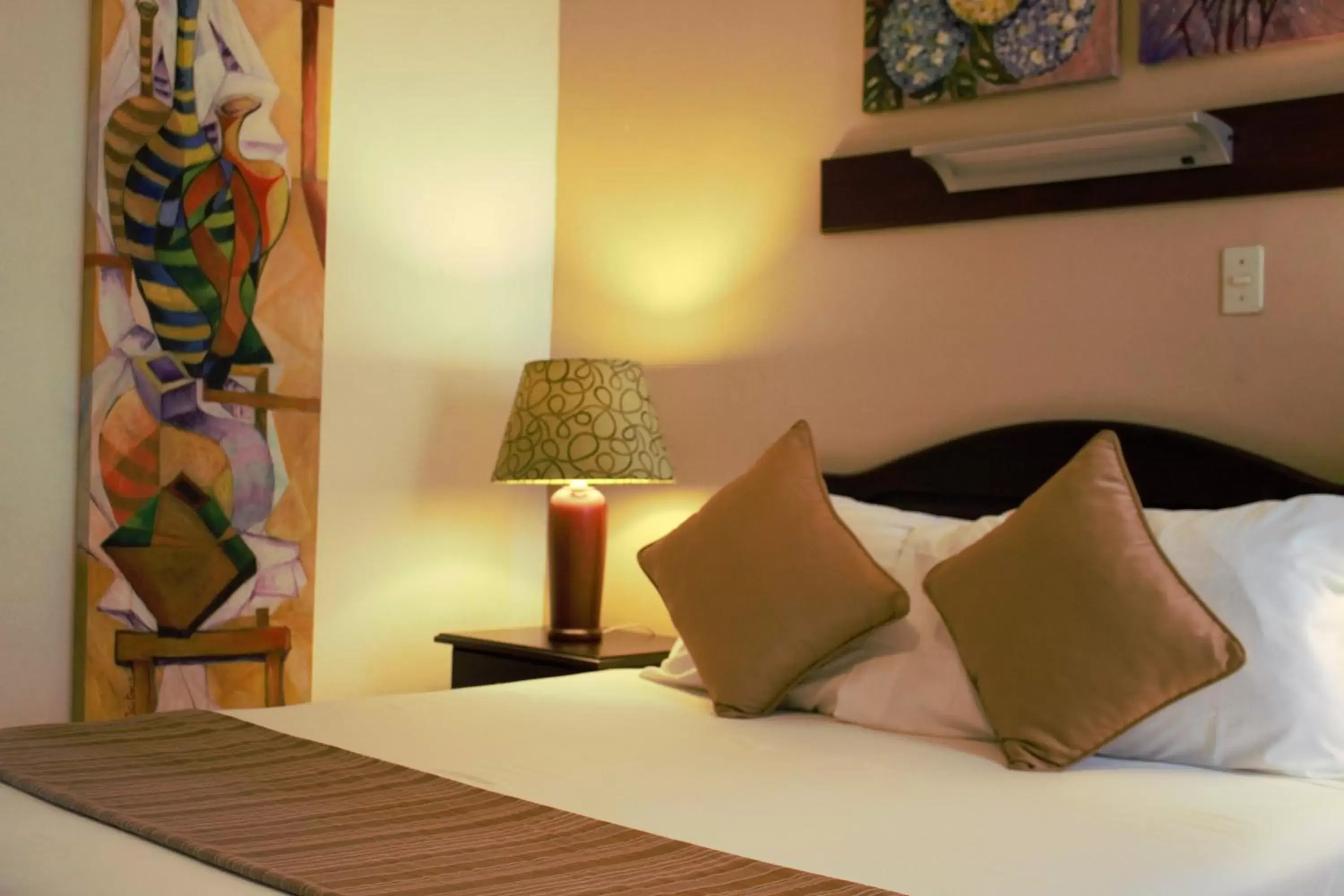 Bed in La Sabana Hotel Suites Apartments