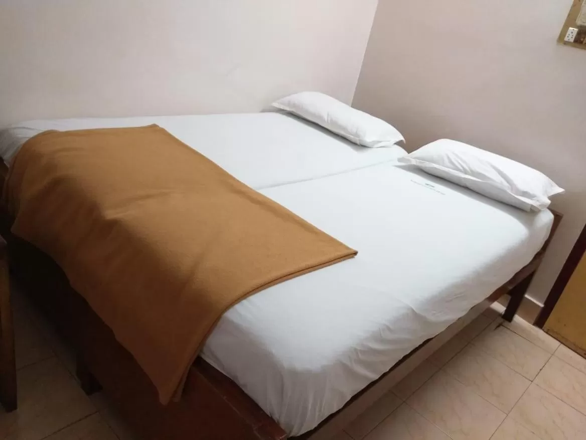 Bed in Anandan Tourist Home