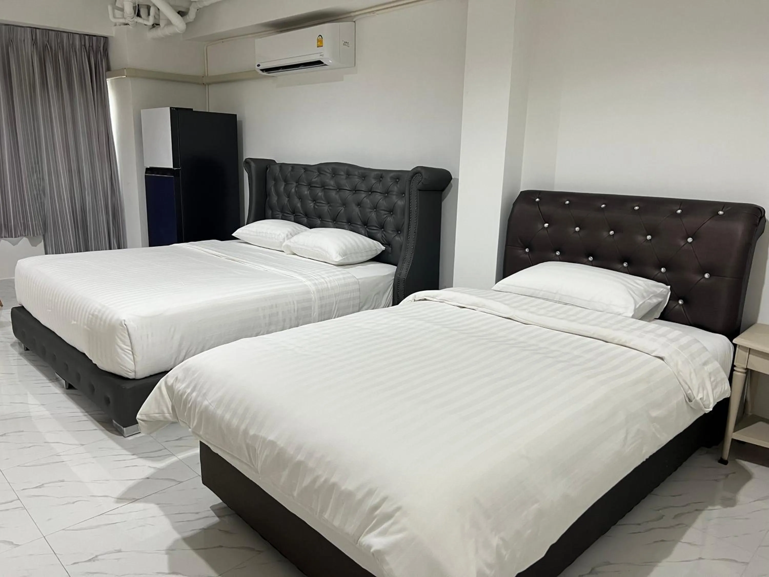 Bed in Mall Suites Hotel