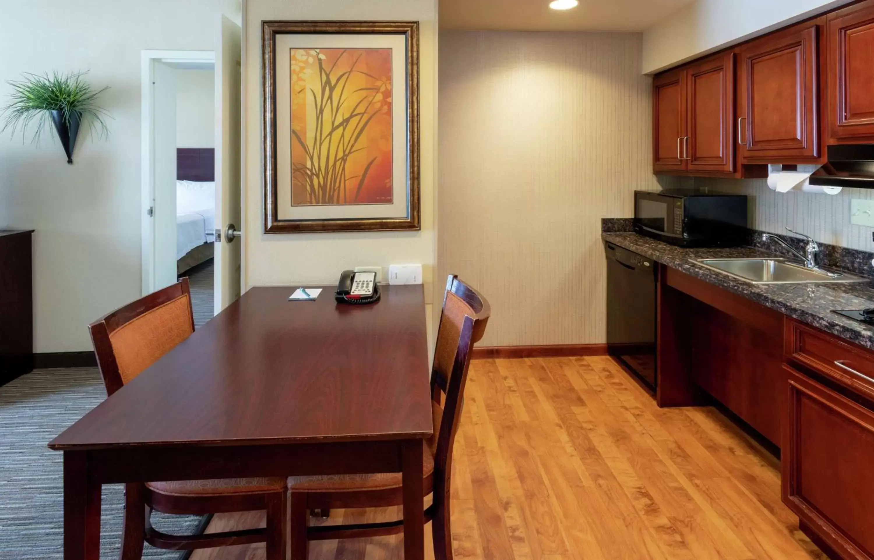 Bedroom, Kitchen/Kitchenette in Homewood Suites by Hilton Minneapolis - Saint Louis Park at West End