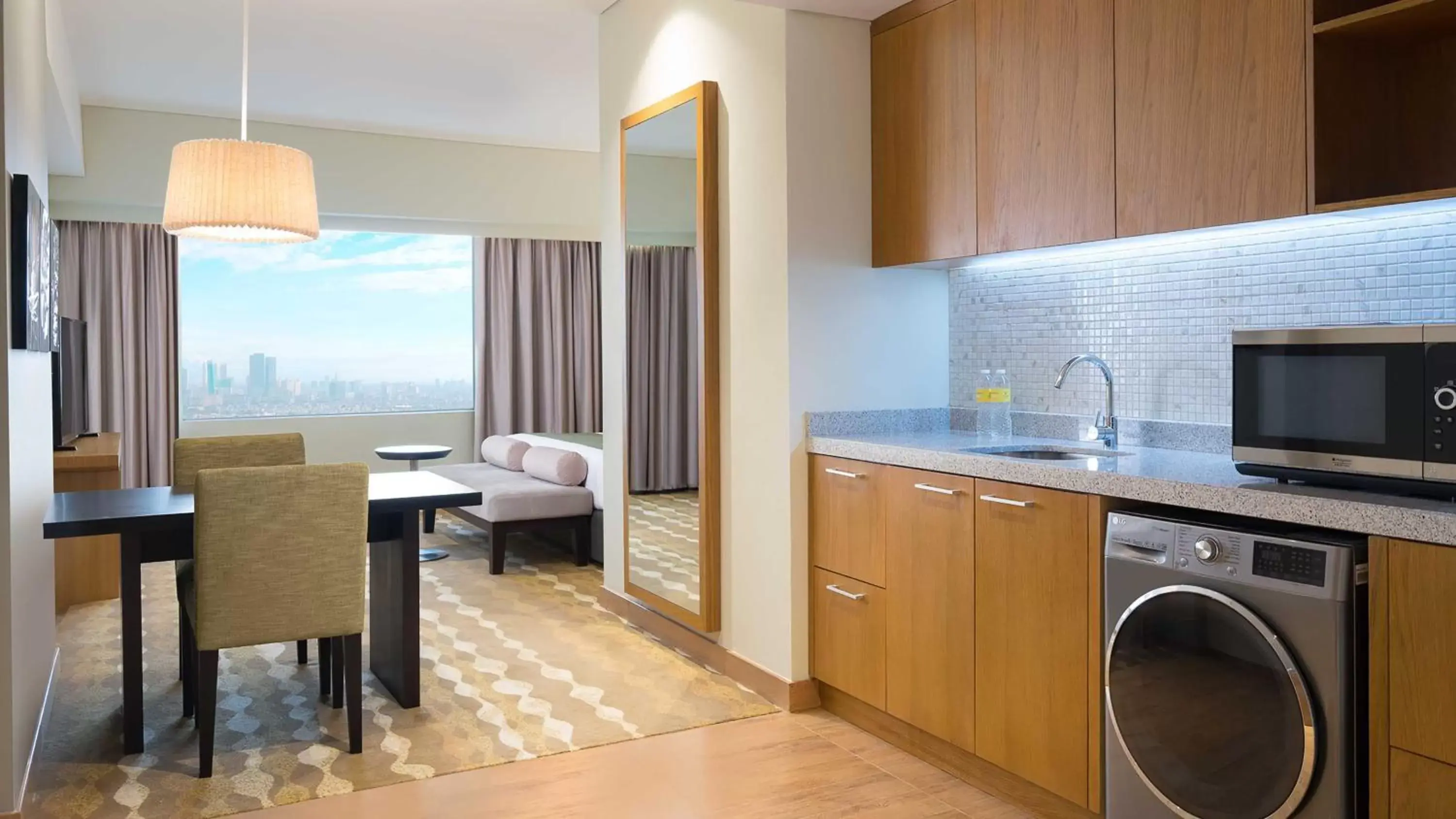 Bedroom, Kitchen/Kitchenette in Holiday Inn & Suites Jakarta Gajah Mada, an IHG Hotel