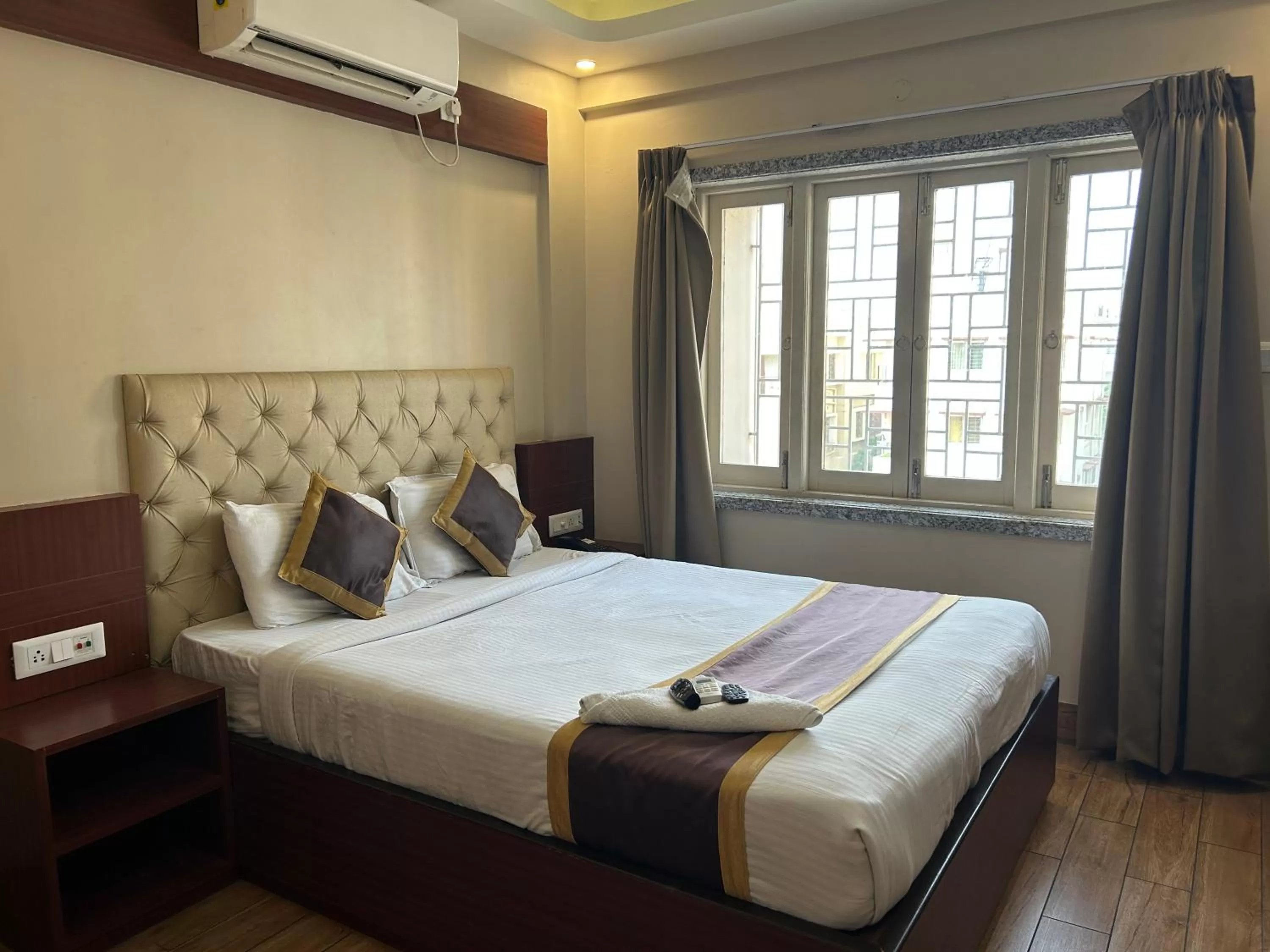 Bed in The Aster Enclave Hotel