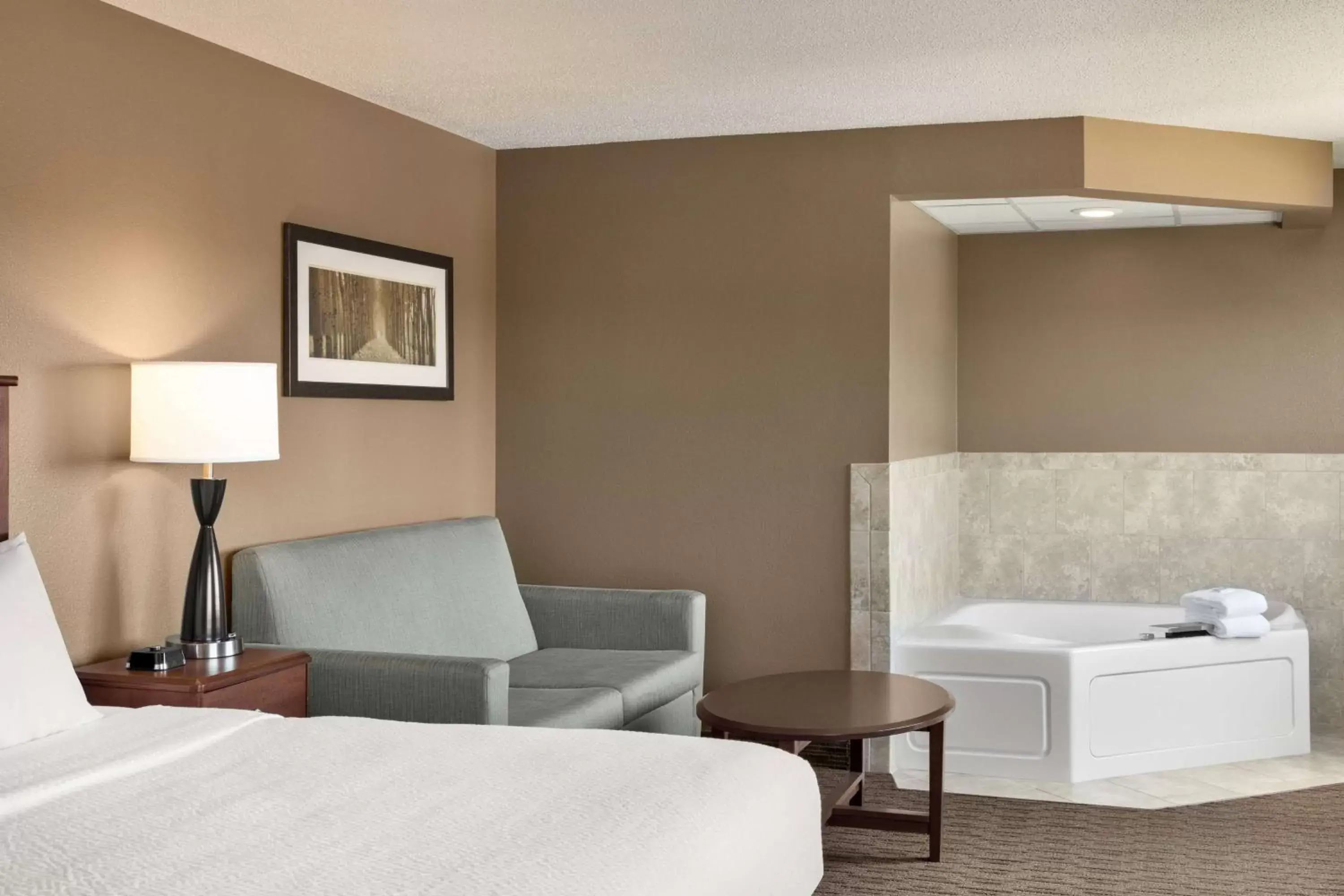 Bed, Seating Area in AmericInn by Wyndham Baudette