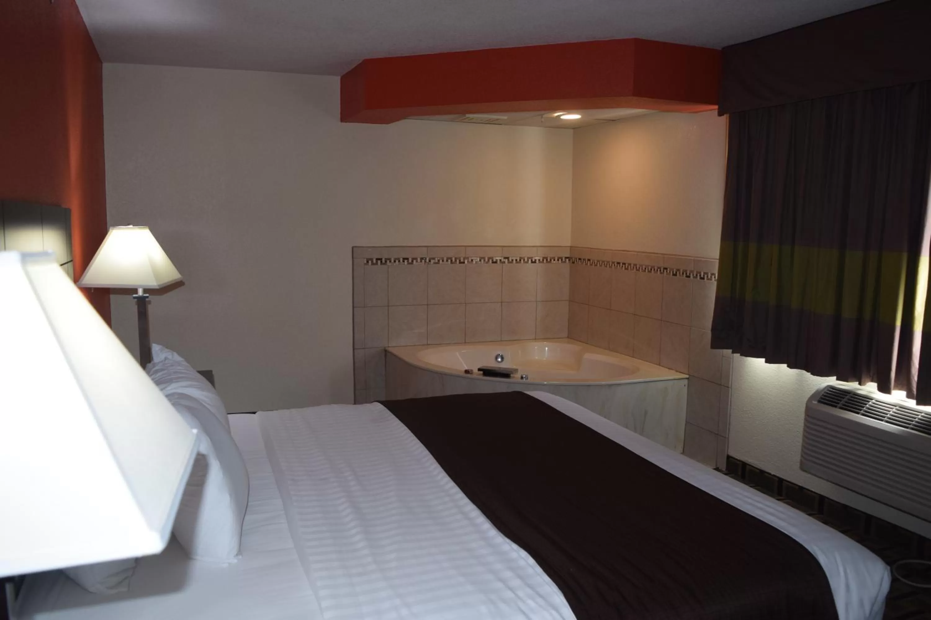 Bed in AmericInn by Wyndham West Burlington