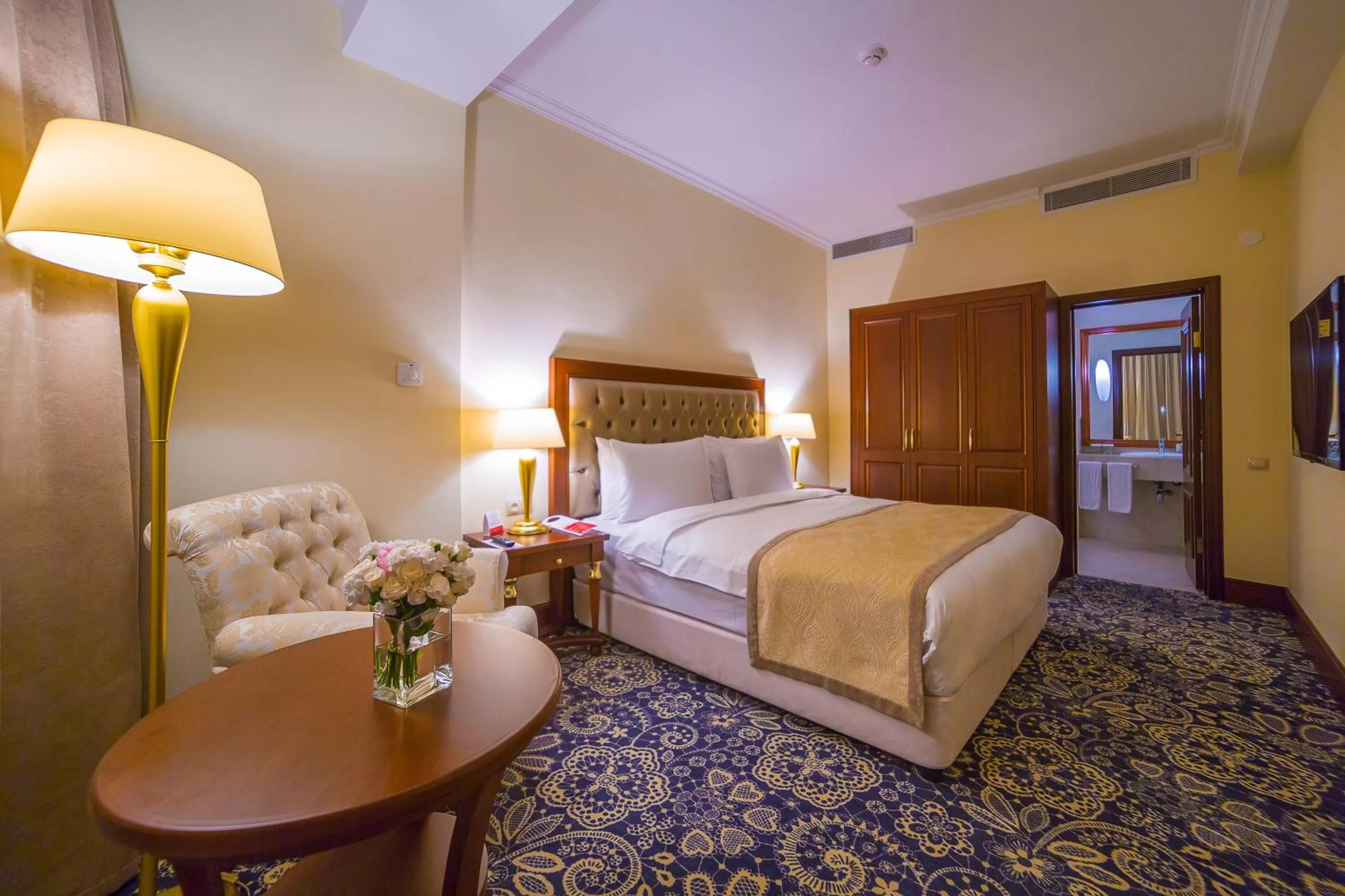 Living room, Bed in Ramada by Wyndham Almaty