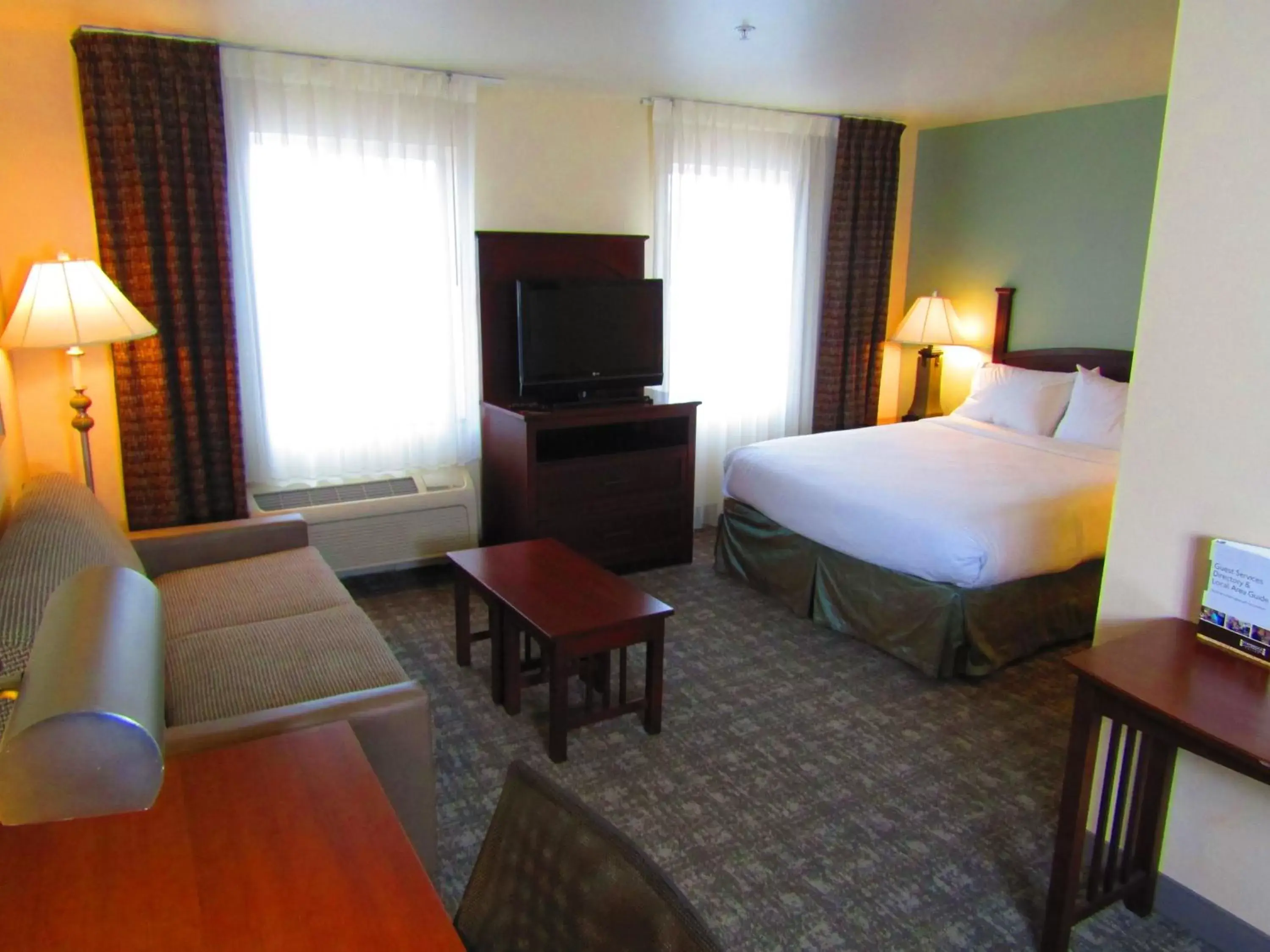 Bedroom, TV/Entertainment Center in Staybridge Suites Rochester University, an IHG Hotel