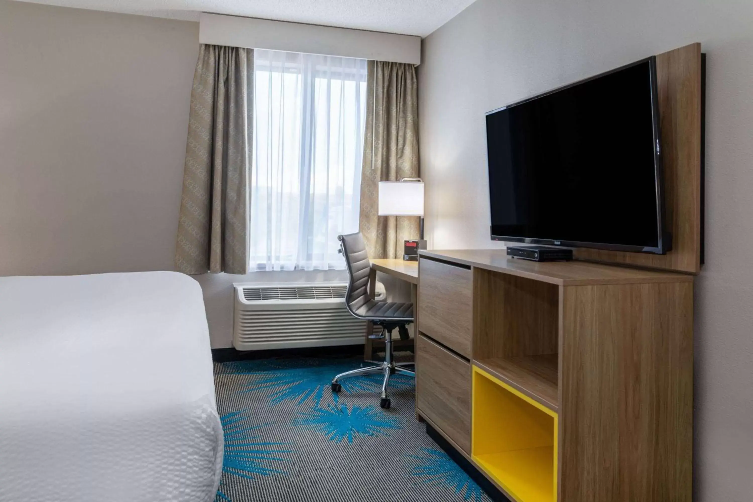 Photo of the whole room, TV/Entertainment Center in Days Inn & Suites by Wyndham Denver International Airport