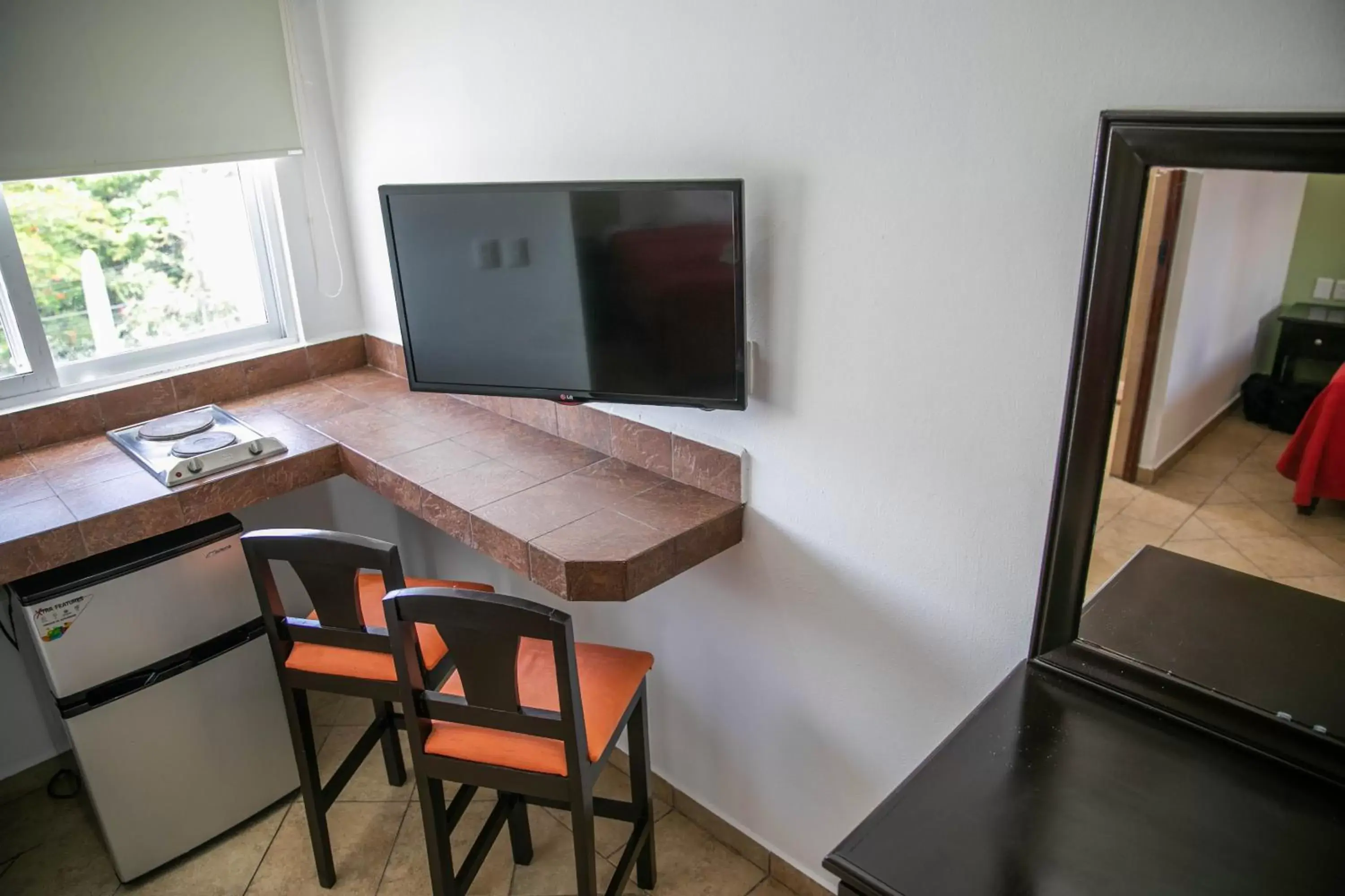 Photo of the whole room, TV/Entertainment Center in Hotel Colonial Playa del Carmen