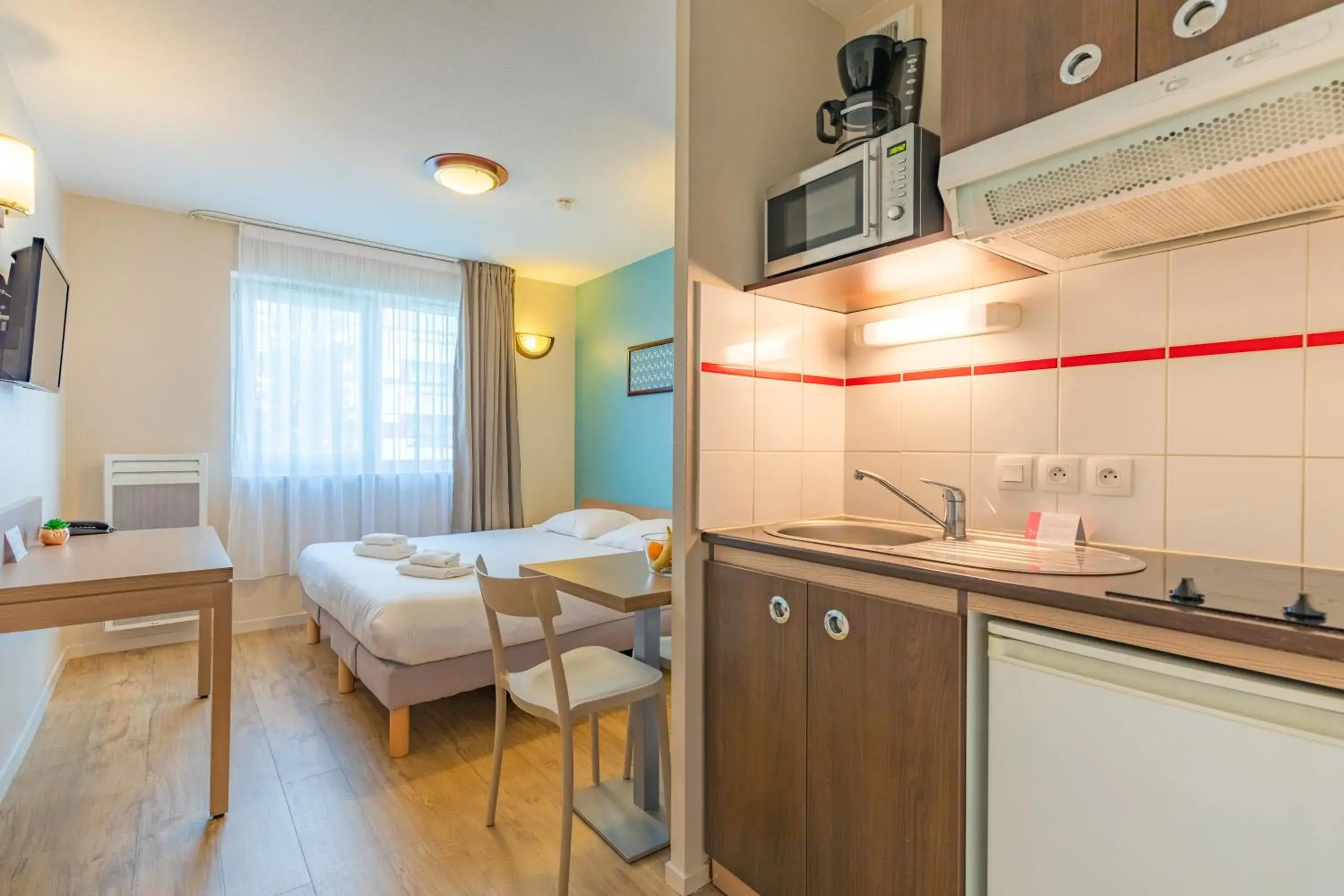 Bed, Kitchen/Kitchenette in Appart City La Roche Sur Yon Centre