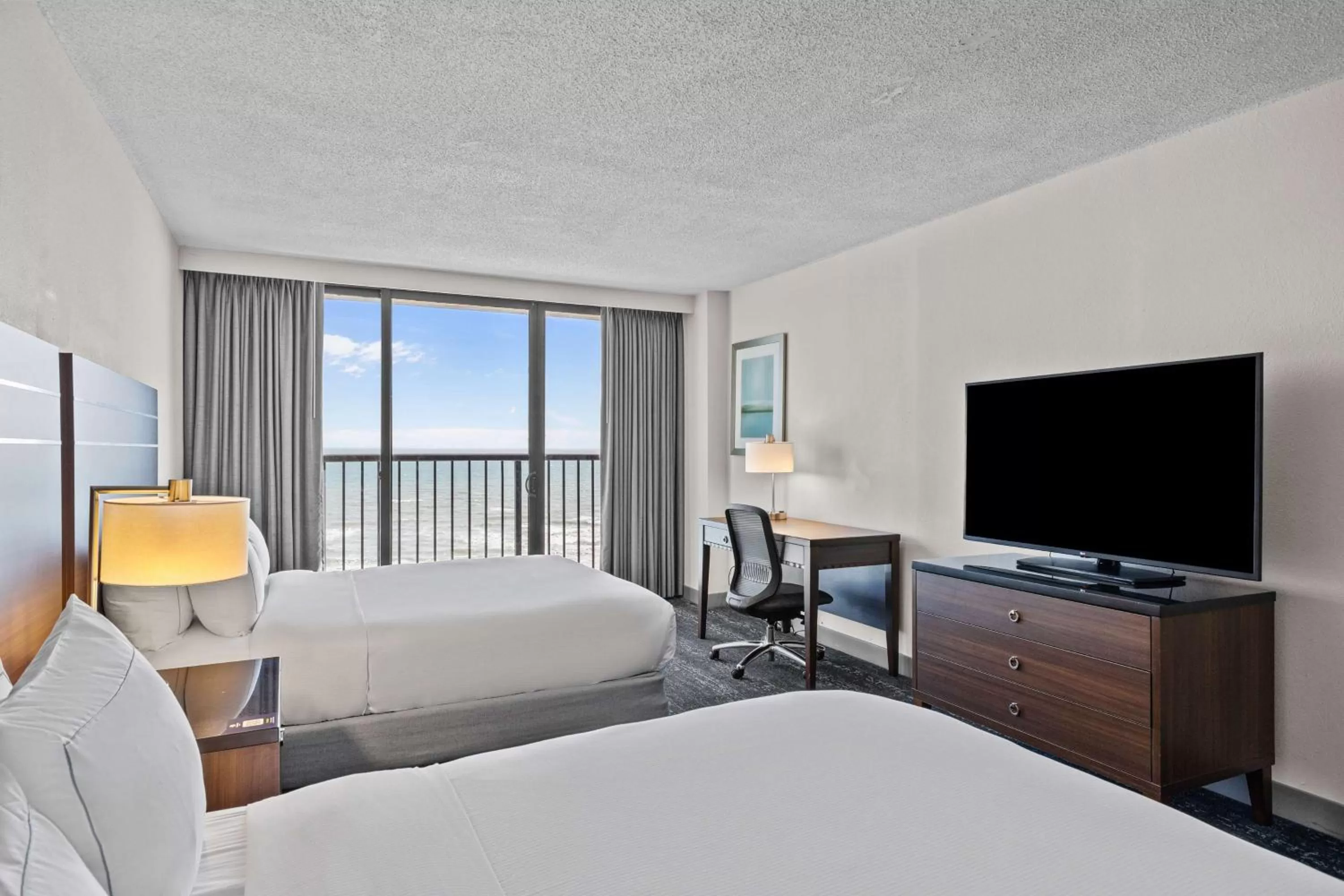 Bed in DoubleTree by Hilton Atlantic Beach Oceanfront