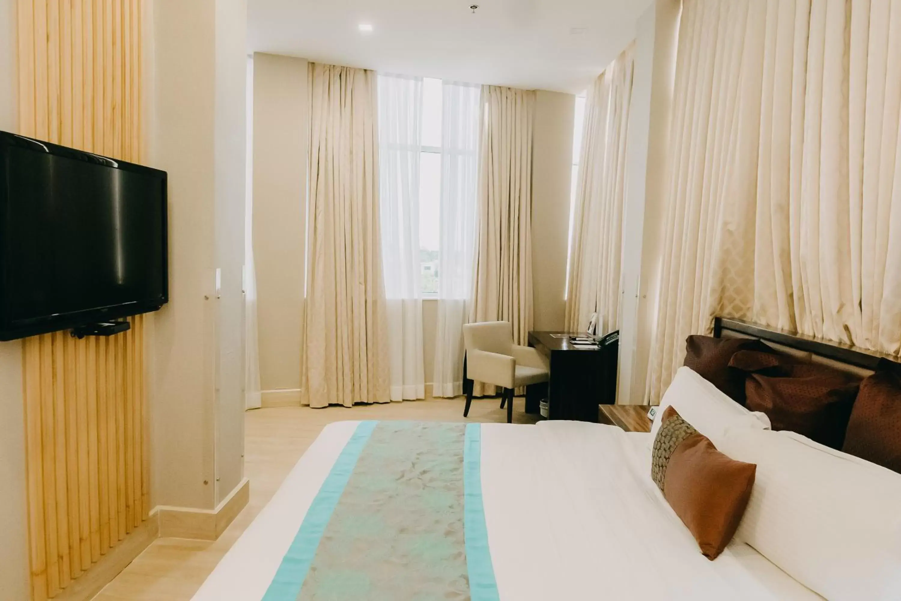 Photo of the whole room, TV/Entertainment Center in Goldberry Suites and Hotel - Mactan