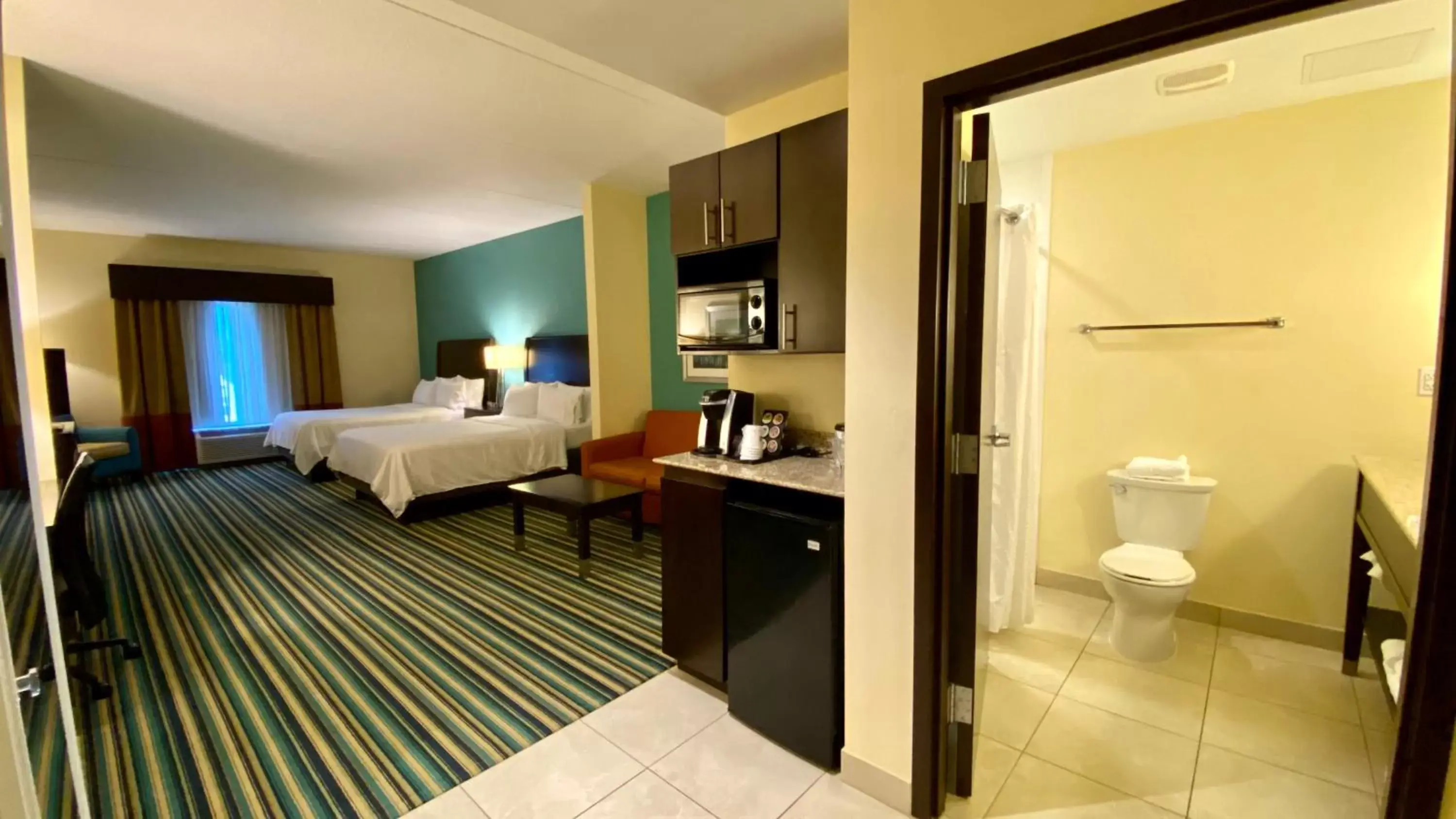 Bedroom, Bathroom in Holiday Inn Express Hotel & Suites Orlando East-UCF Area, an IHG Hotel