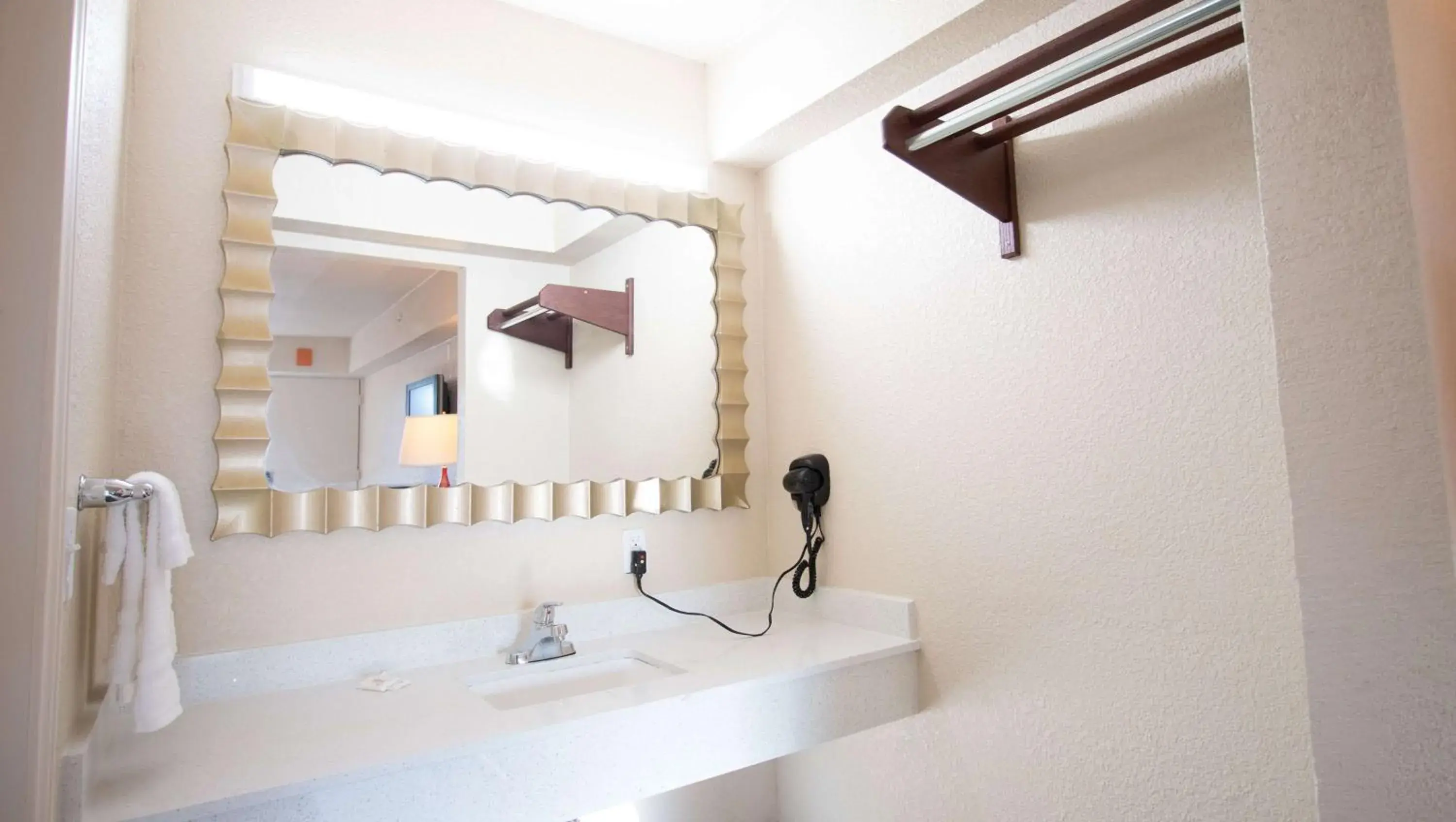 Bathroom in Magnuson Extended Stay and Suites Airport Hotel