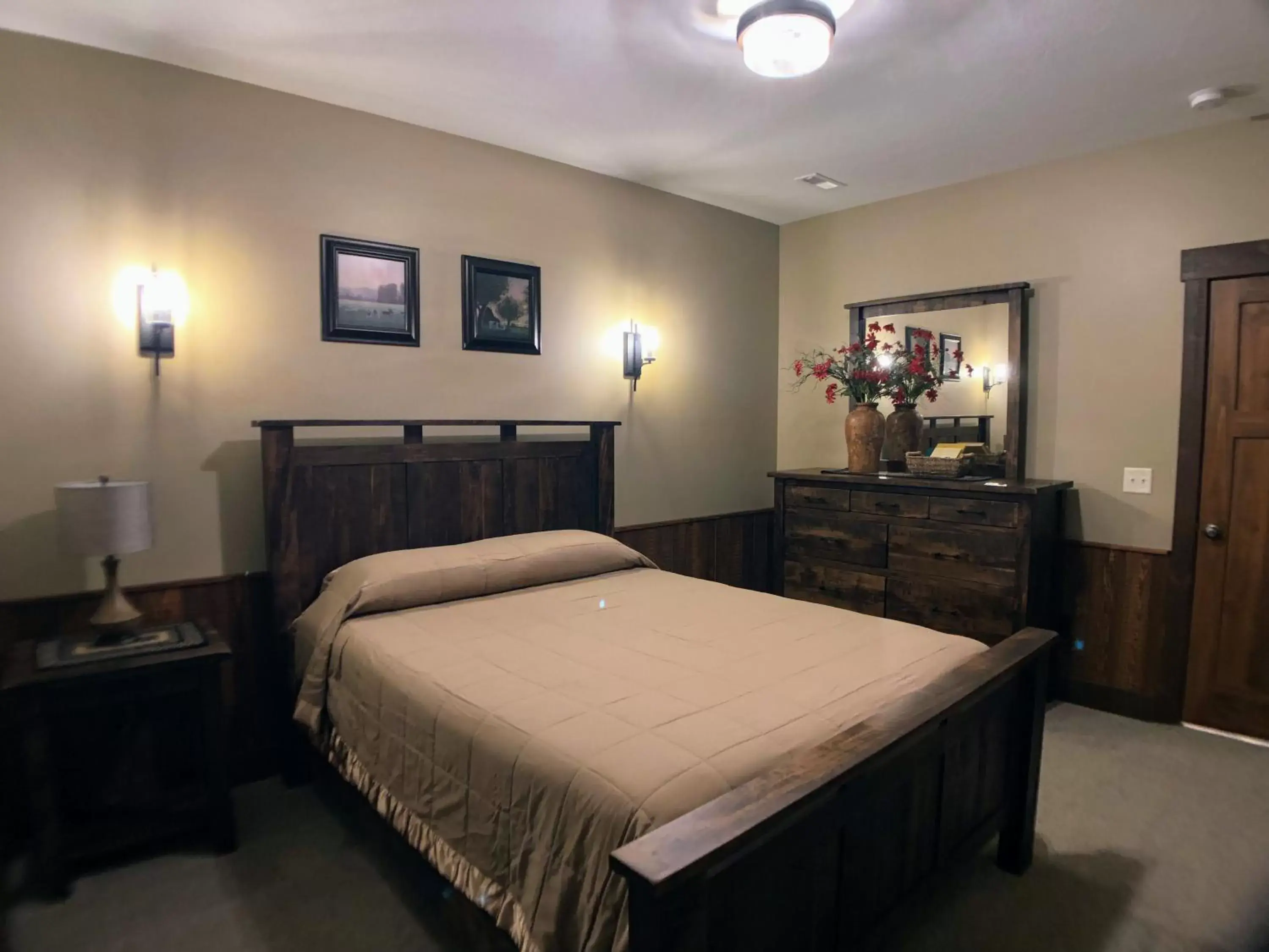 Bed in Sojourner's Lodge & Log Cabin Suites