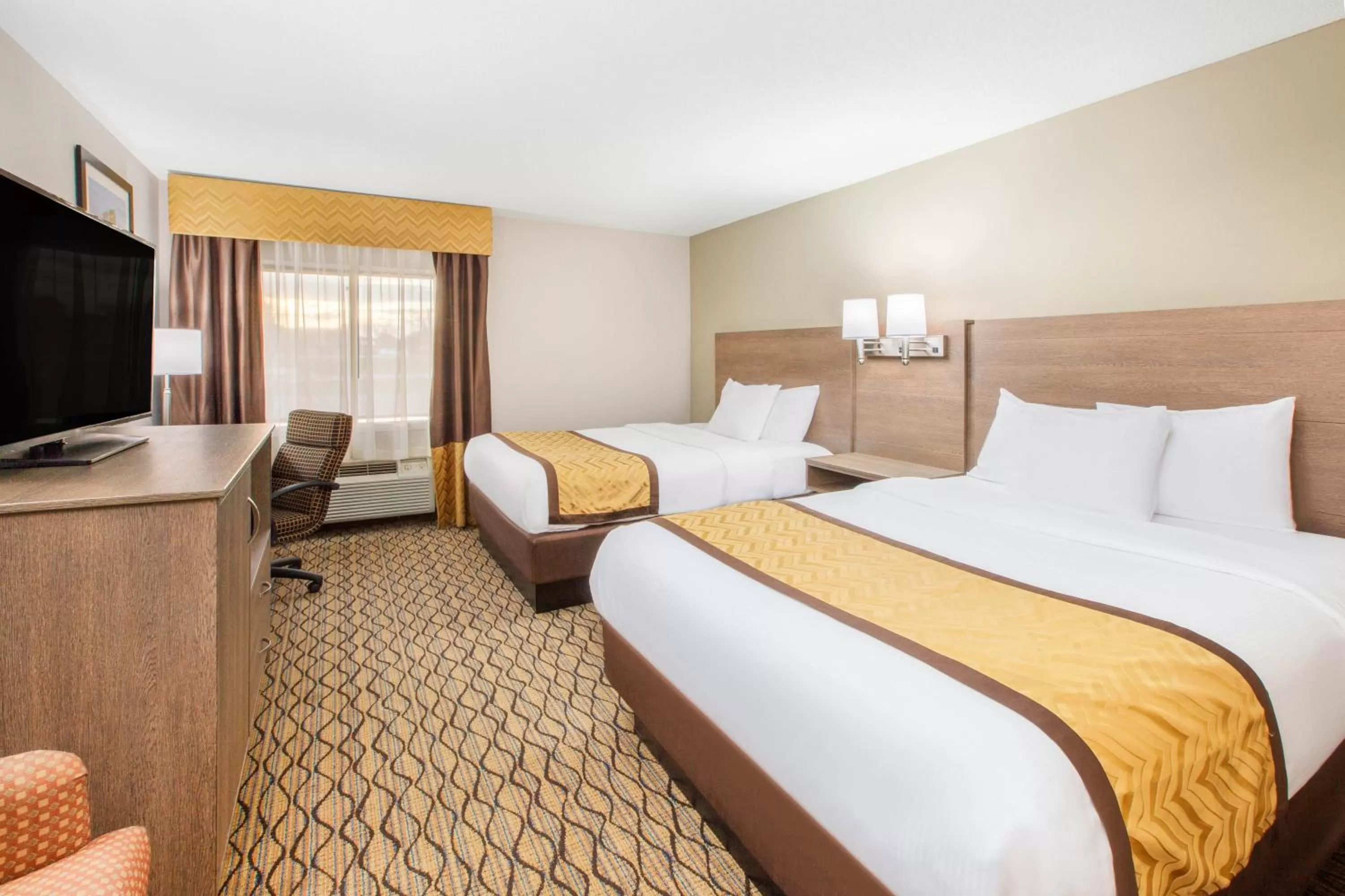 Bed in Baymont by Wyndham Grand Rapids Airport