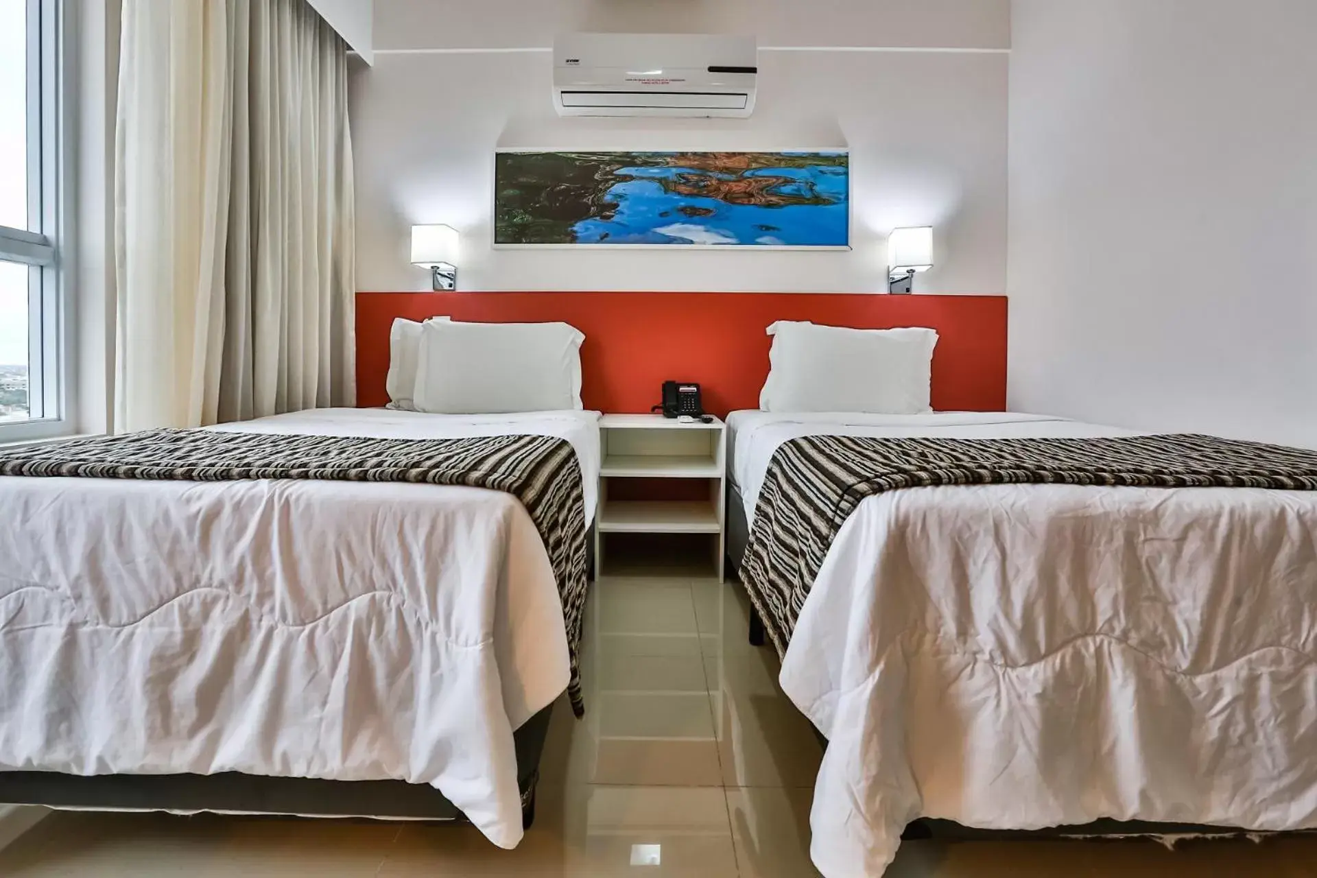 air conditioner, Bed in Ramada Hotel & Suites Campos Pelinca