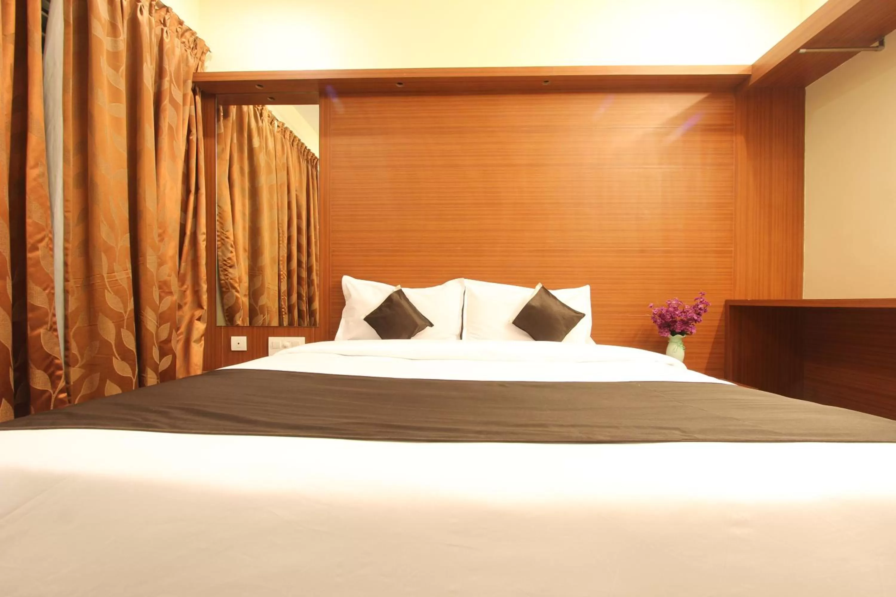 Bed in The Grand Inn Mysore