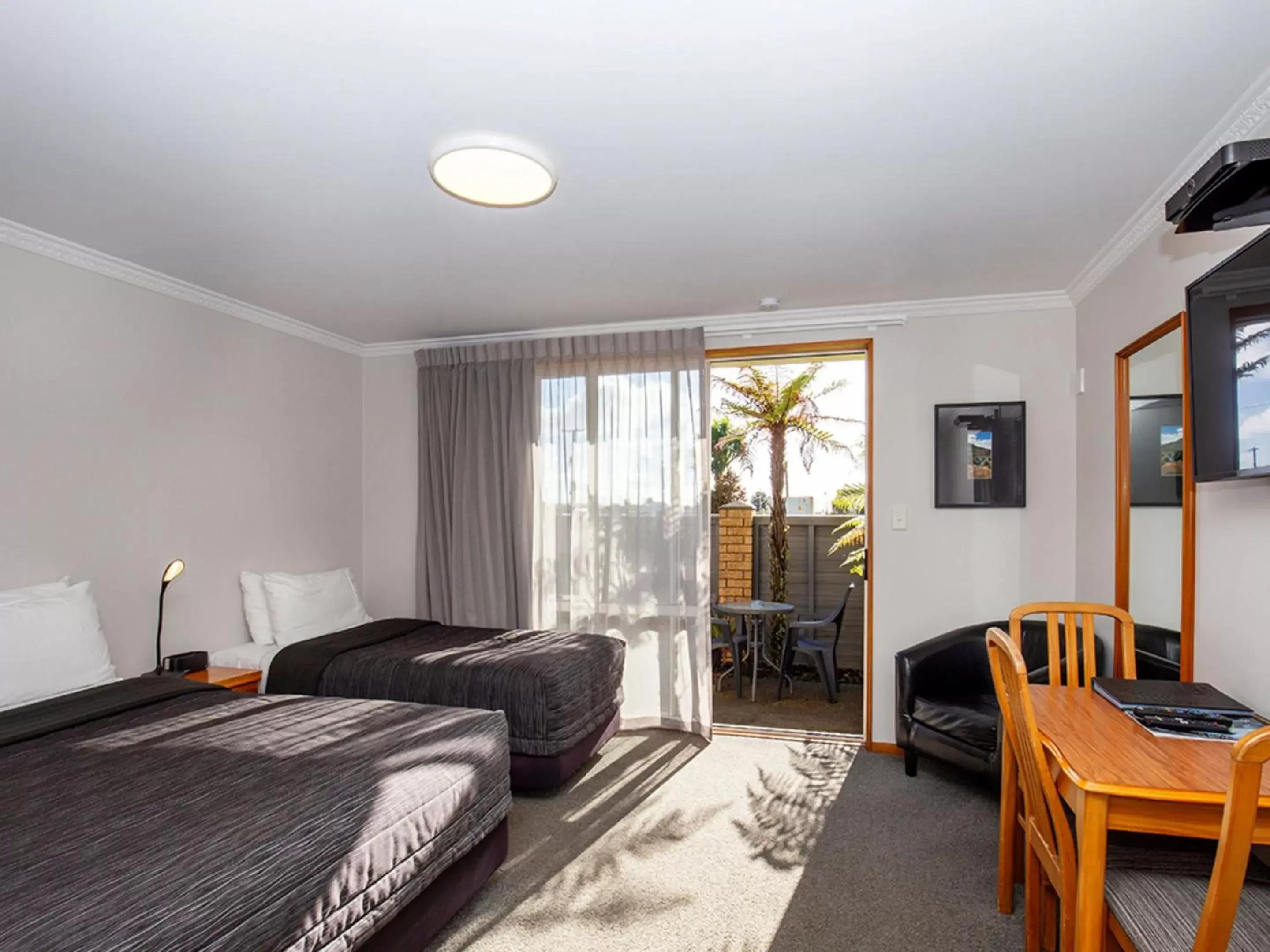 Bedroom, Seating Area in ASURE Chelsea Gateway Motor Lodge