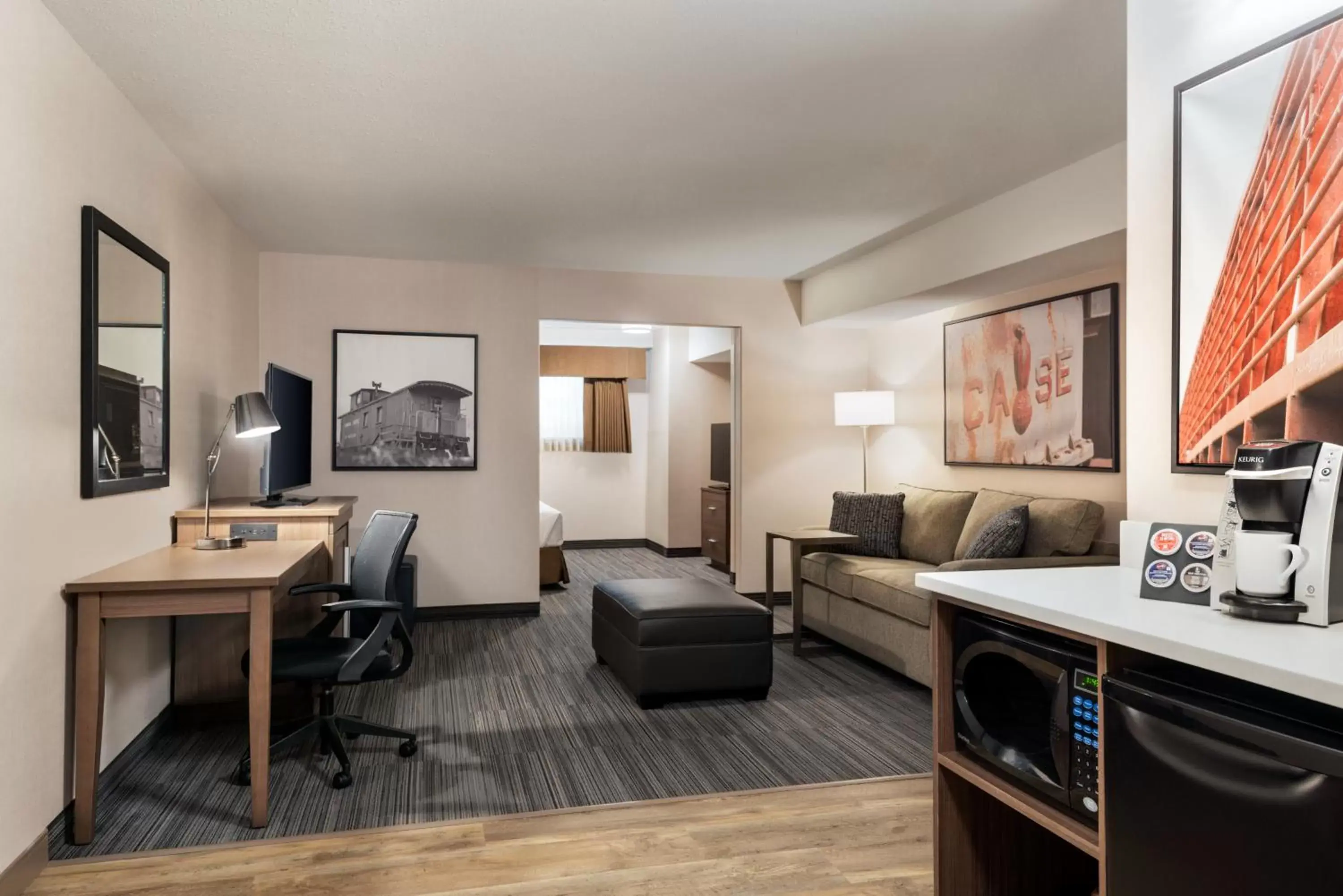 Living room, TV/Entertainment Center in Ramada by Wyndham Airdrie Hotel & Suites