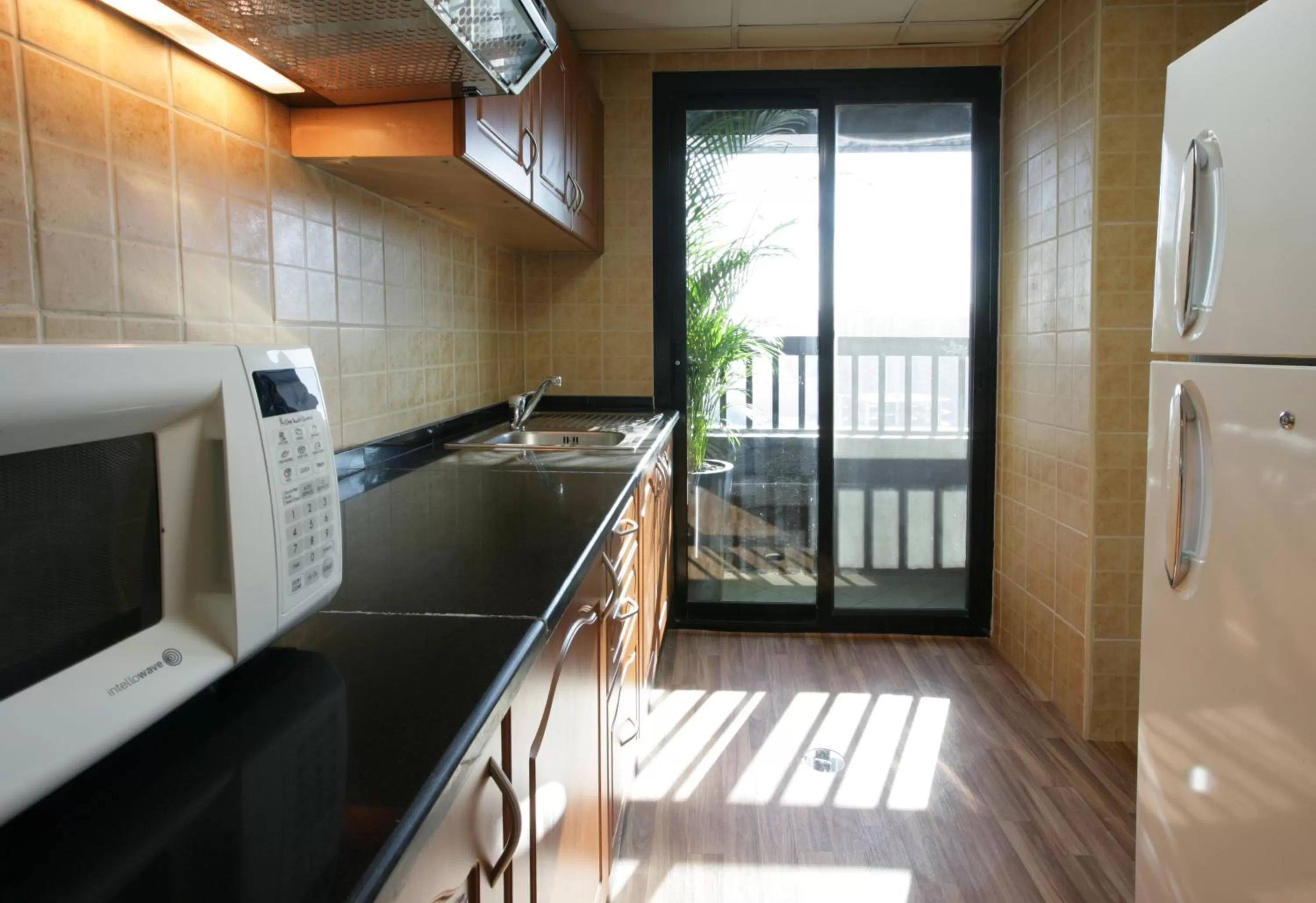 Kitchen or kitchenette in Ramada Hotel & Suites by Wyndham Ajman