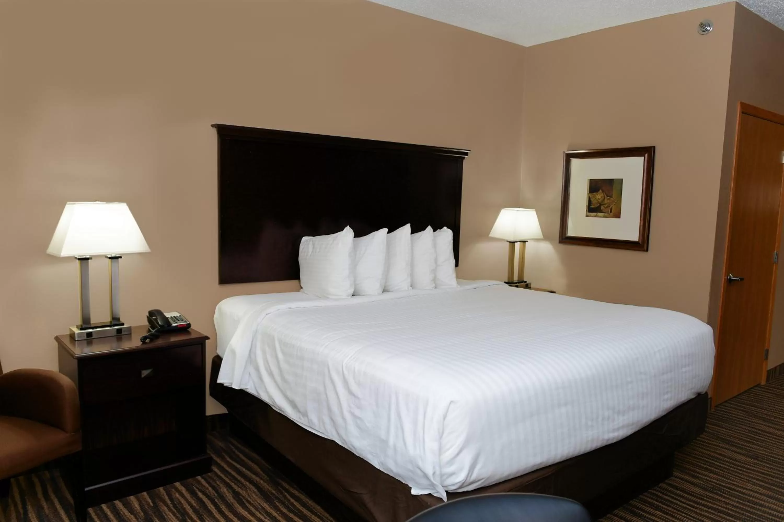 Bed in Cobblestone Inn & Suites - Denison | Majestic Hills