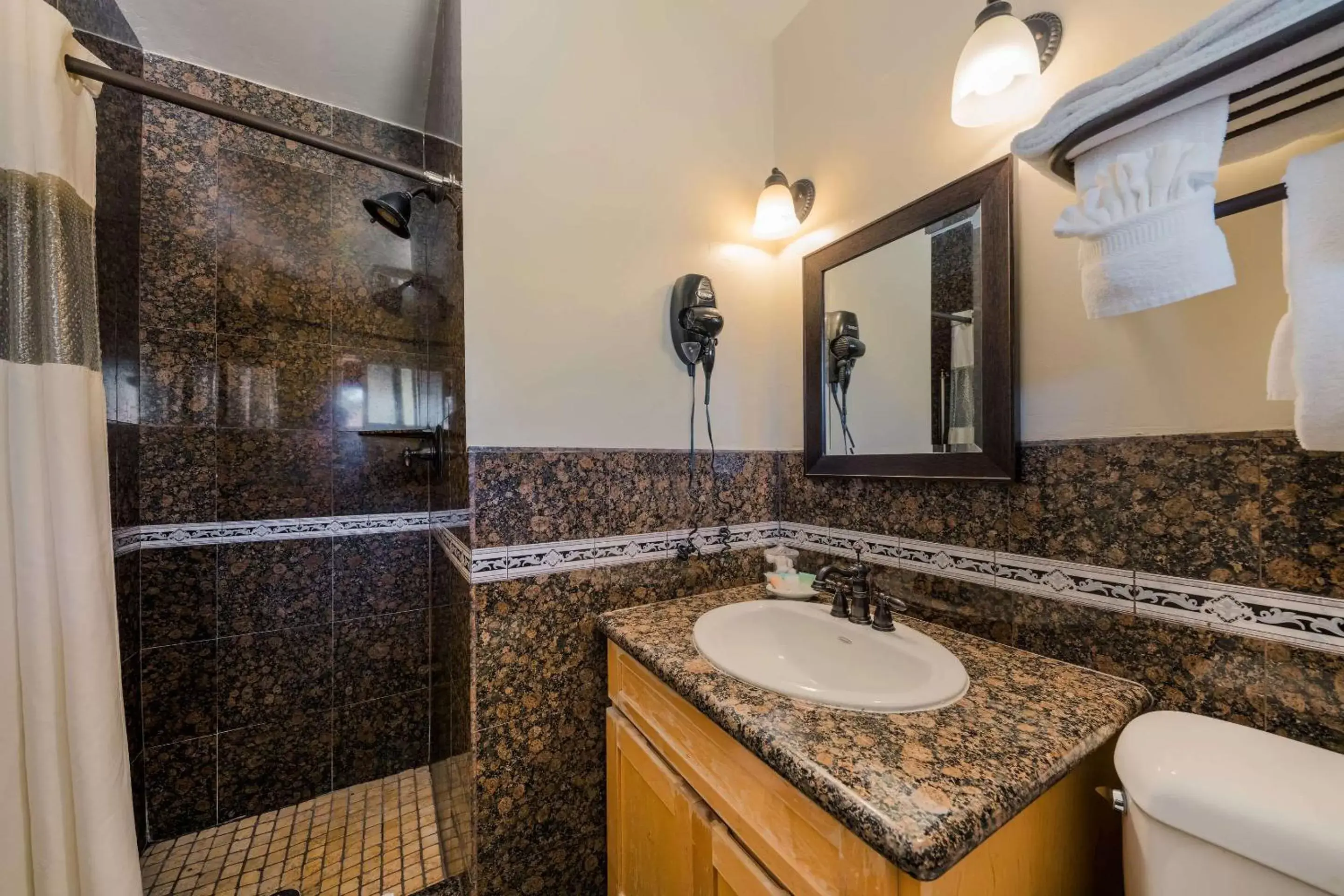 Shower, Bathroom in Clarion Collection Carmel Oaks Inn