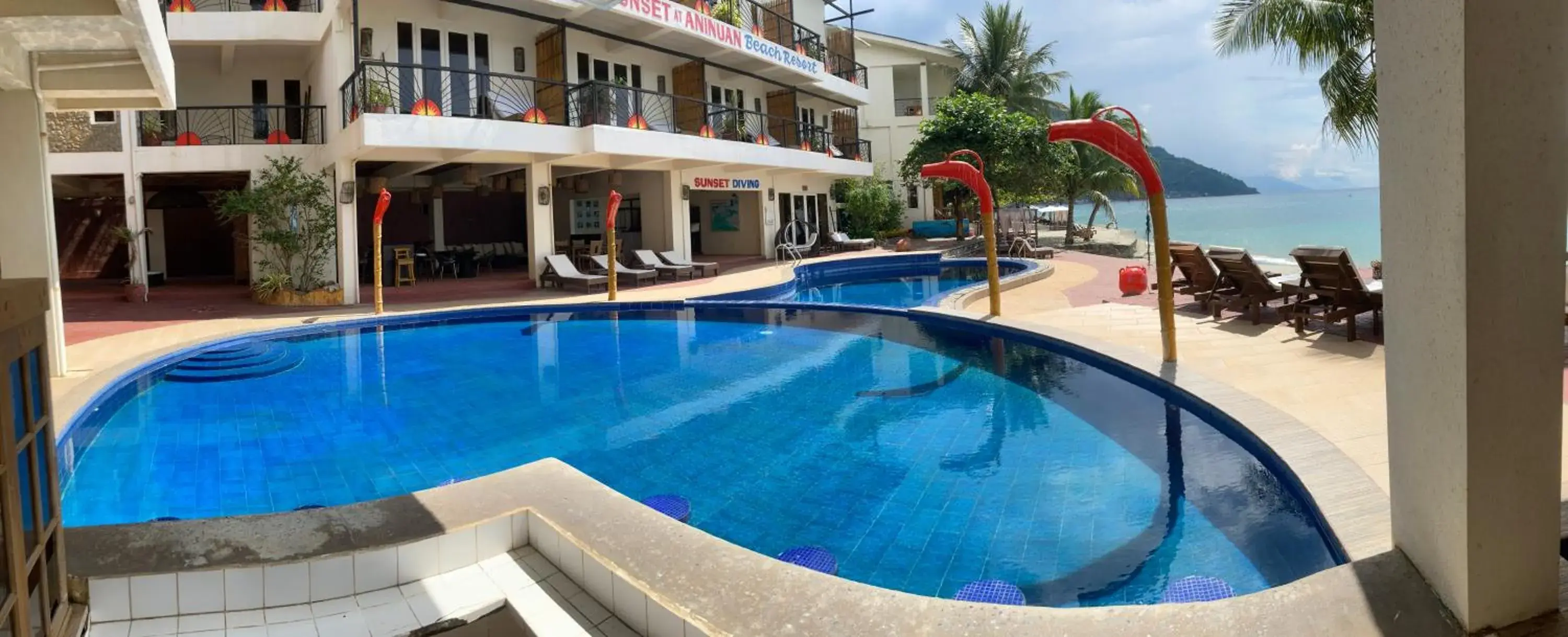 Swimming Pool in Sunset At Aninuan Beach Resort