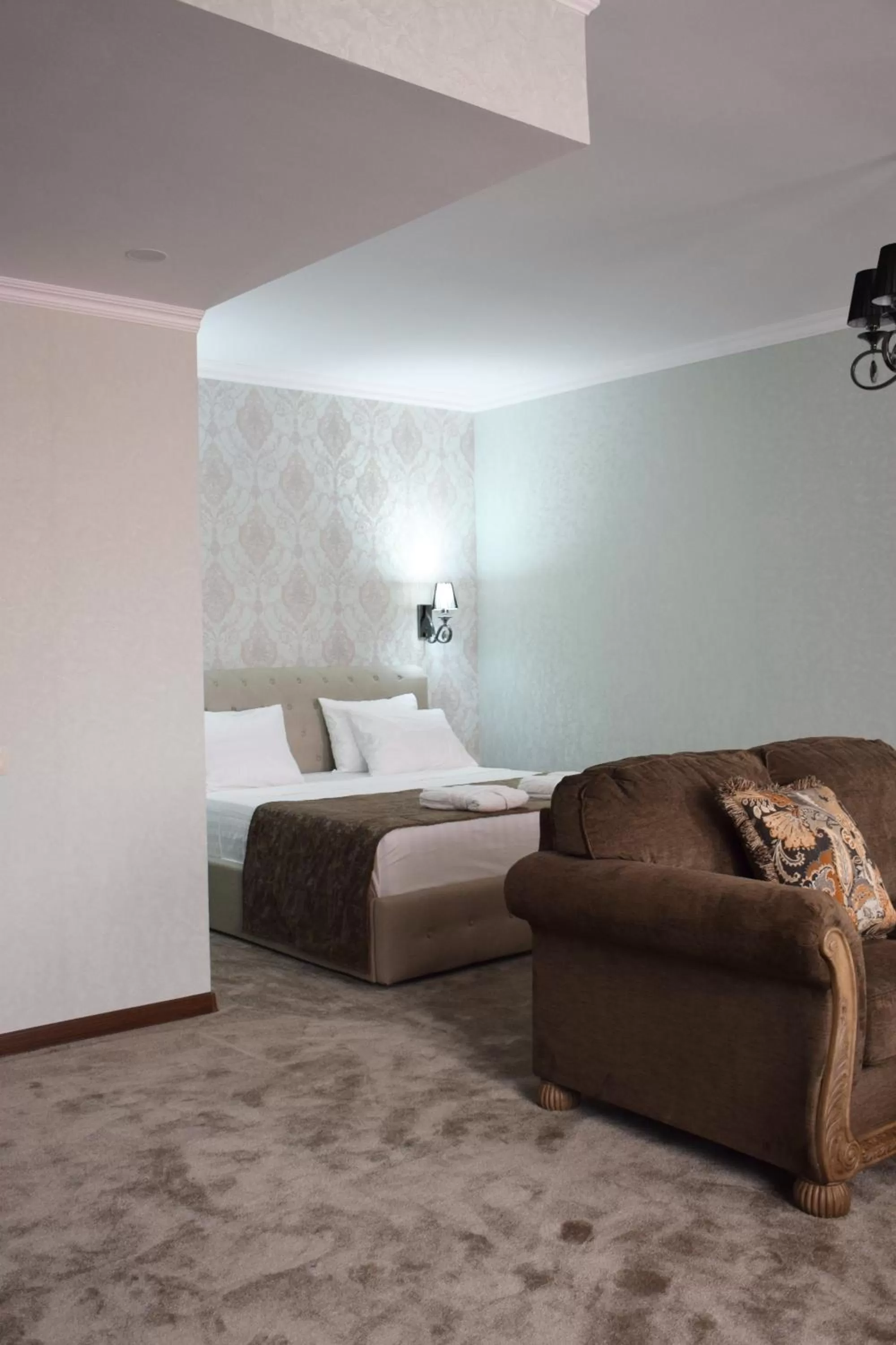 Living room, Bed in MirOtel Hotel