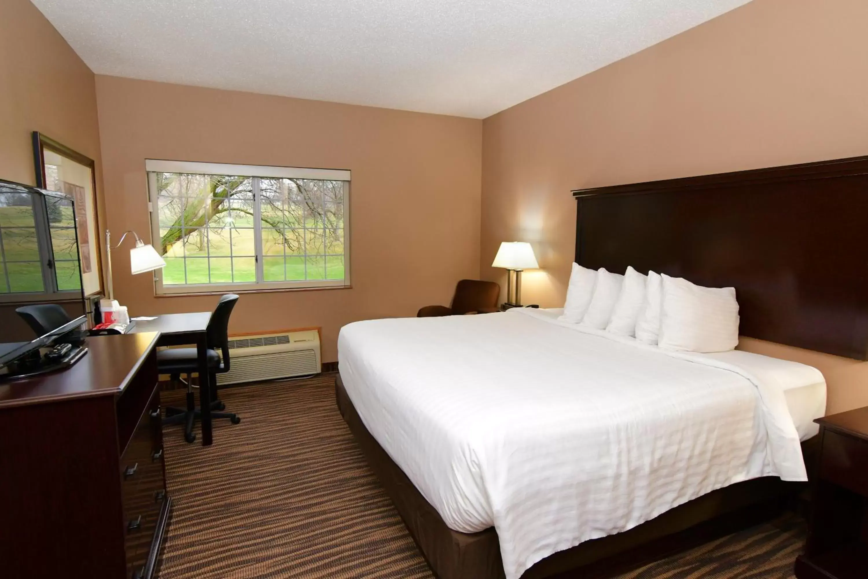 Bed in Cobblestone Inn & Suites - Denison | Majestic Hills