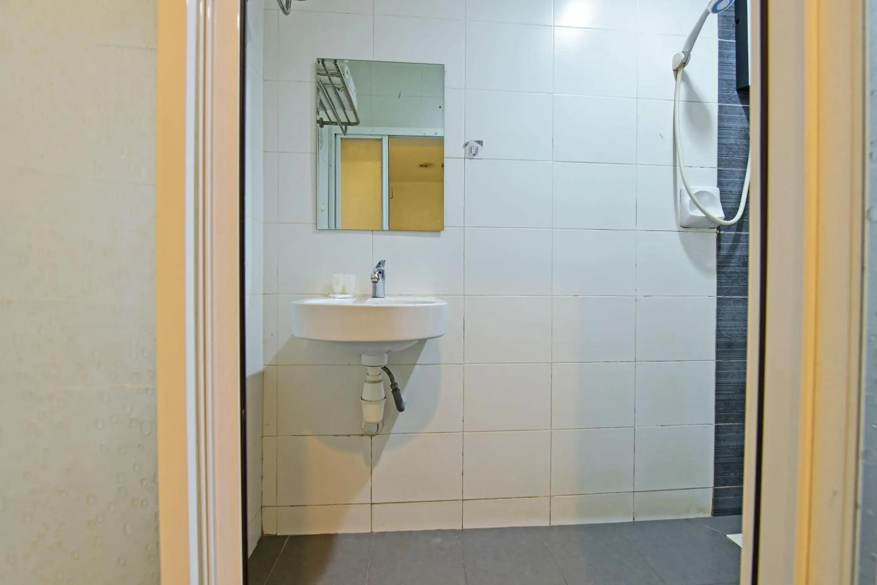 Bathroom in OYO 90853 New Soho Hotel