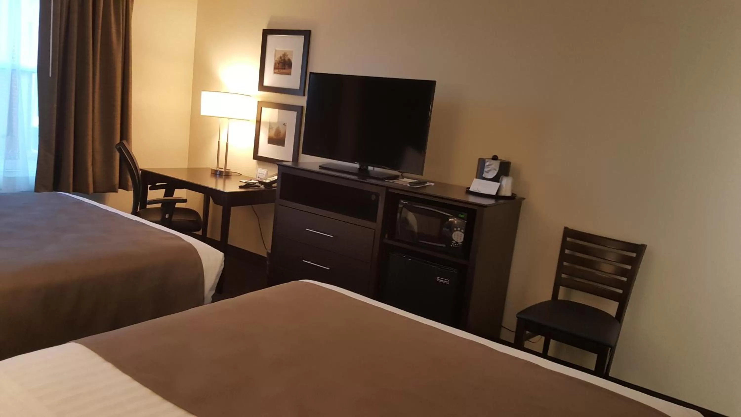 Photo of the whole room, Bed in AmericInn & Suites Burnsville, MN
