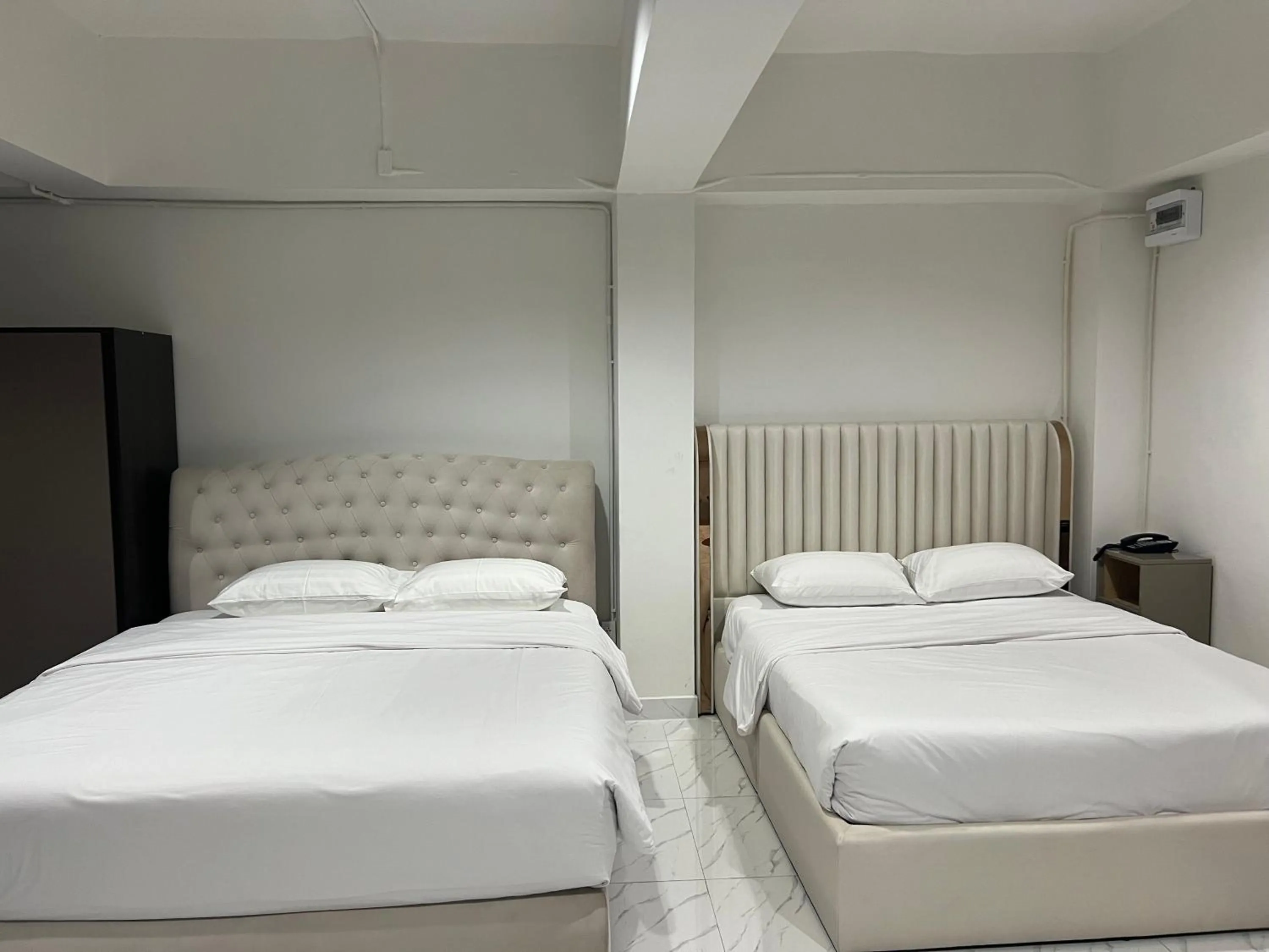 Bed in Mall Suites Hotel