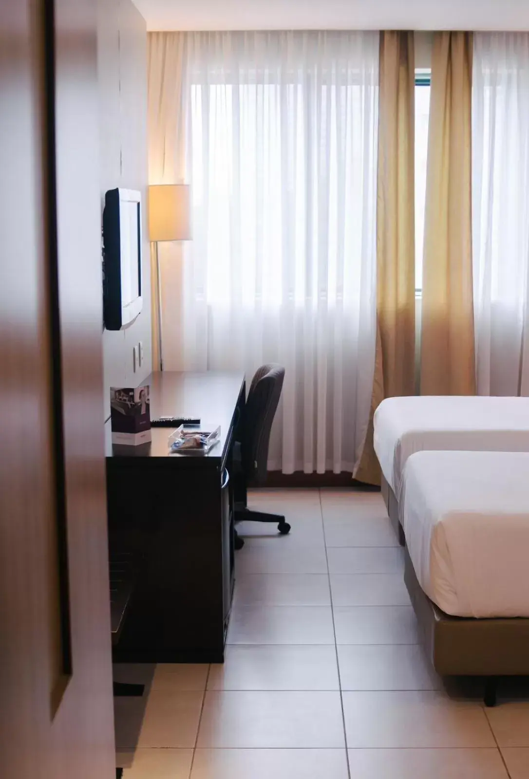 Bed, TV/Entertainment Center in Mercure Salvador Pituba