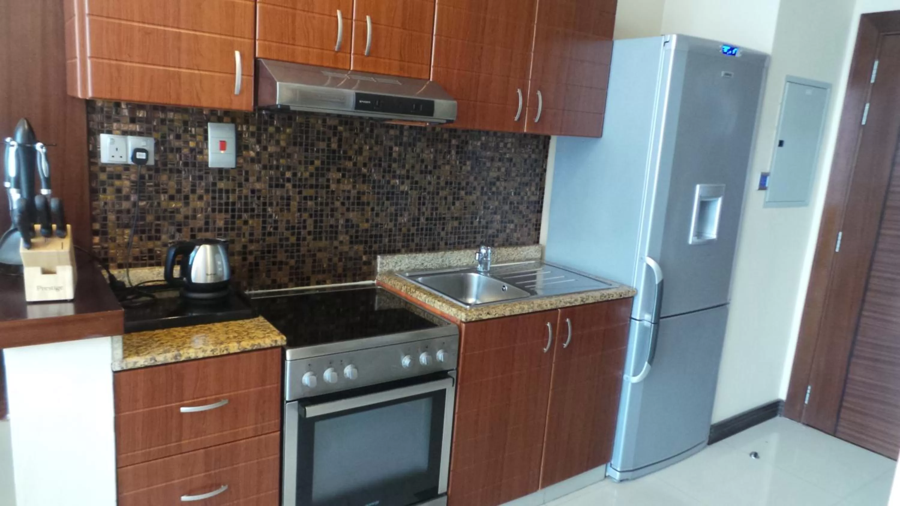 Kitchen or kitchenette in Xclusive Maples Hotel Apartment