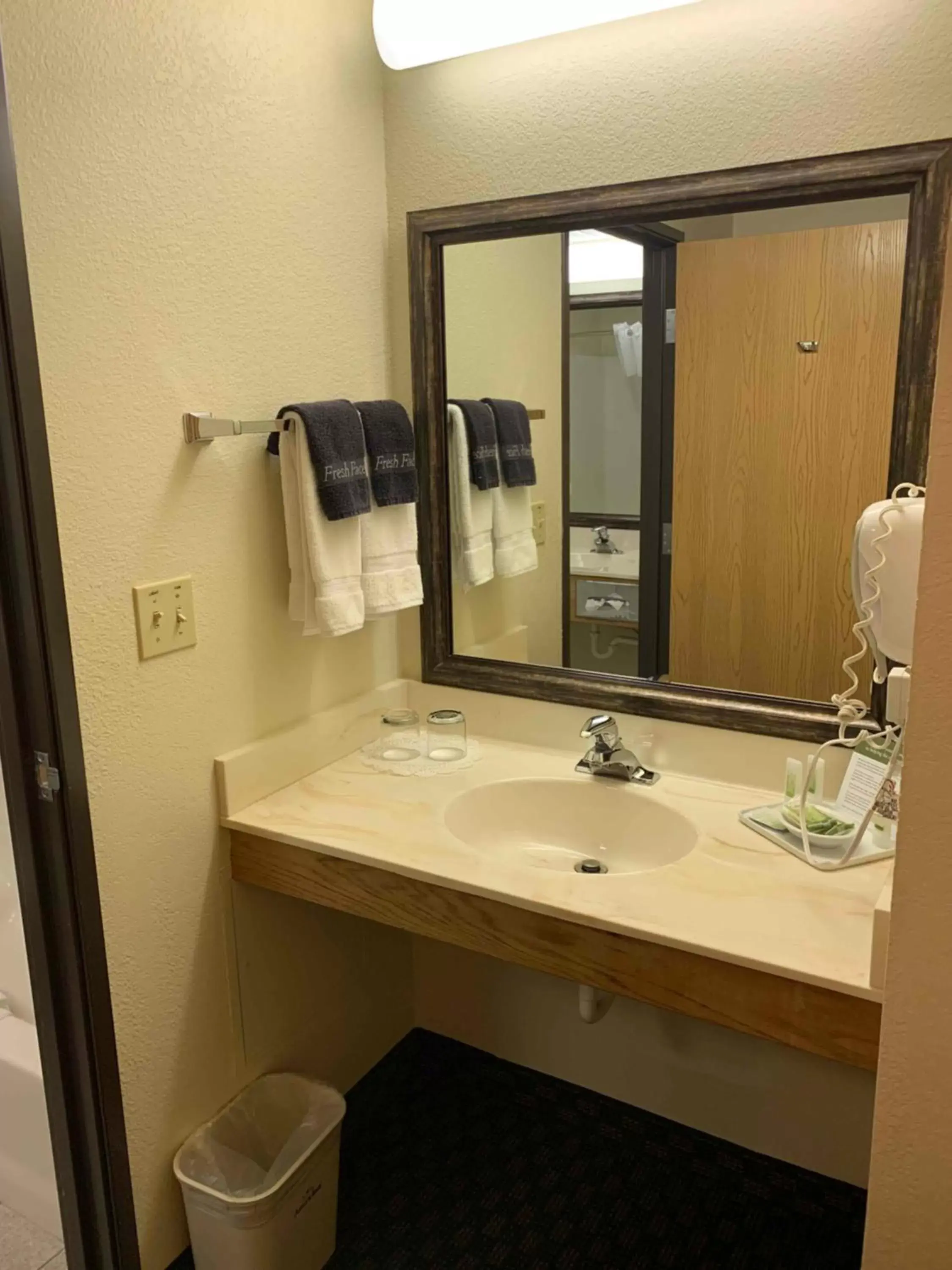 Bathroom in AmericInn by Wyndham Cody