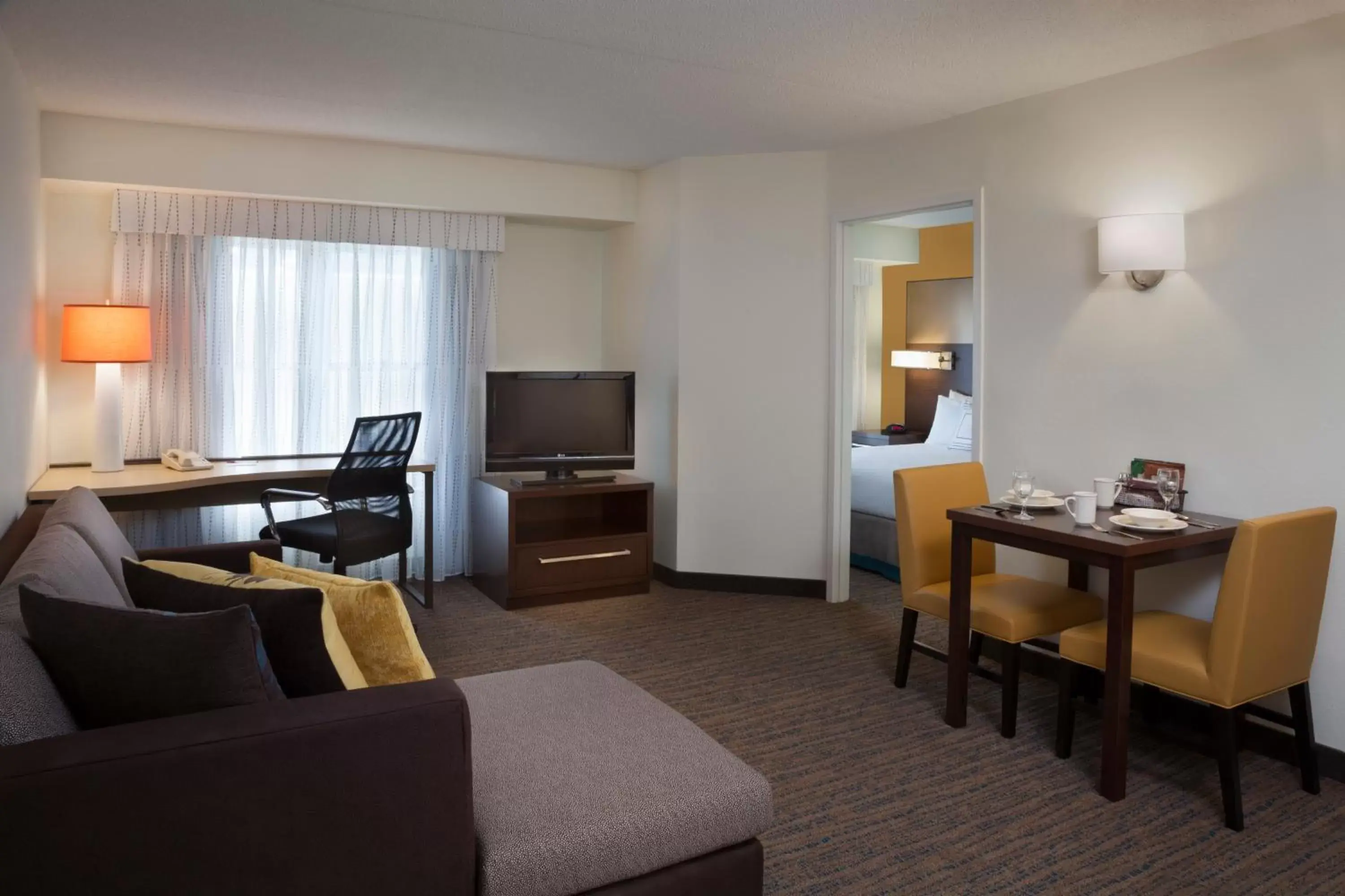 Bed, Seating Area in Cambridge Suites Mississauga