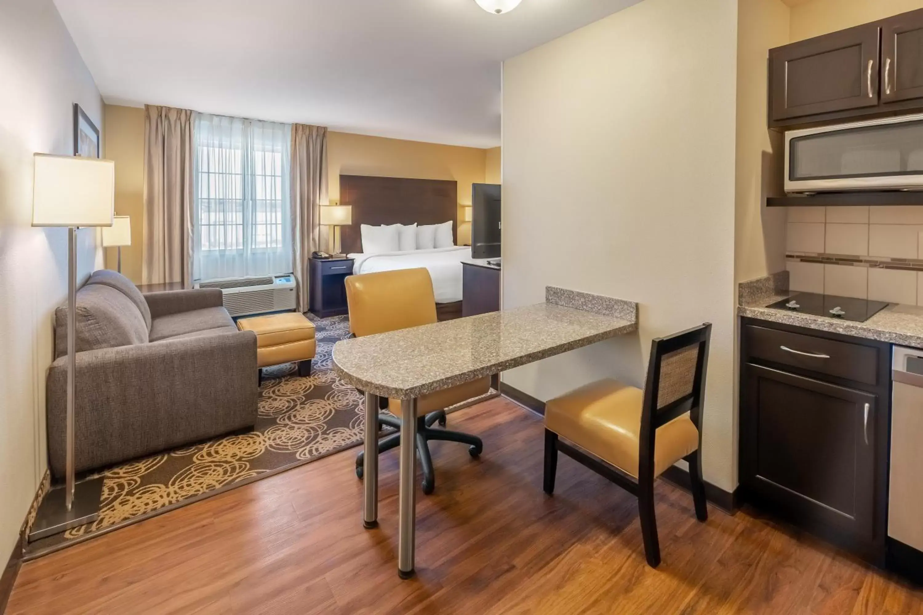 Bed, Seating Area in Landmark Suites - Williston