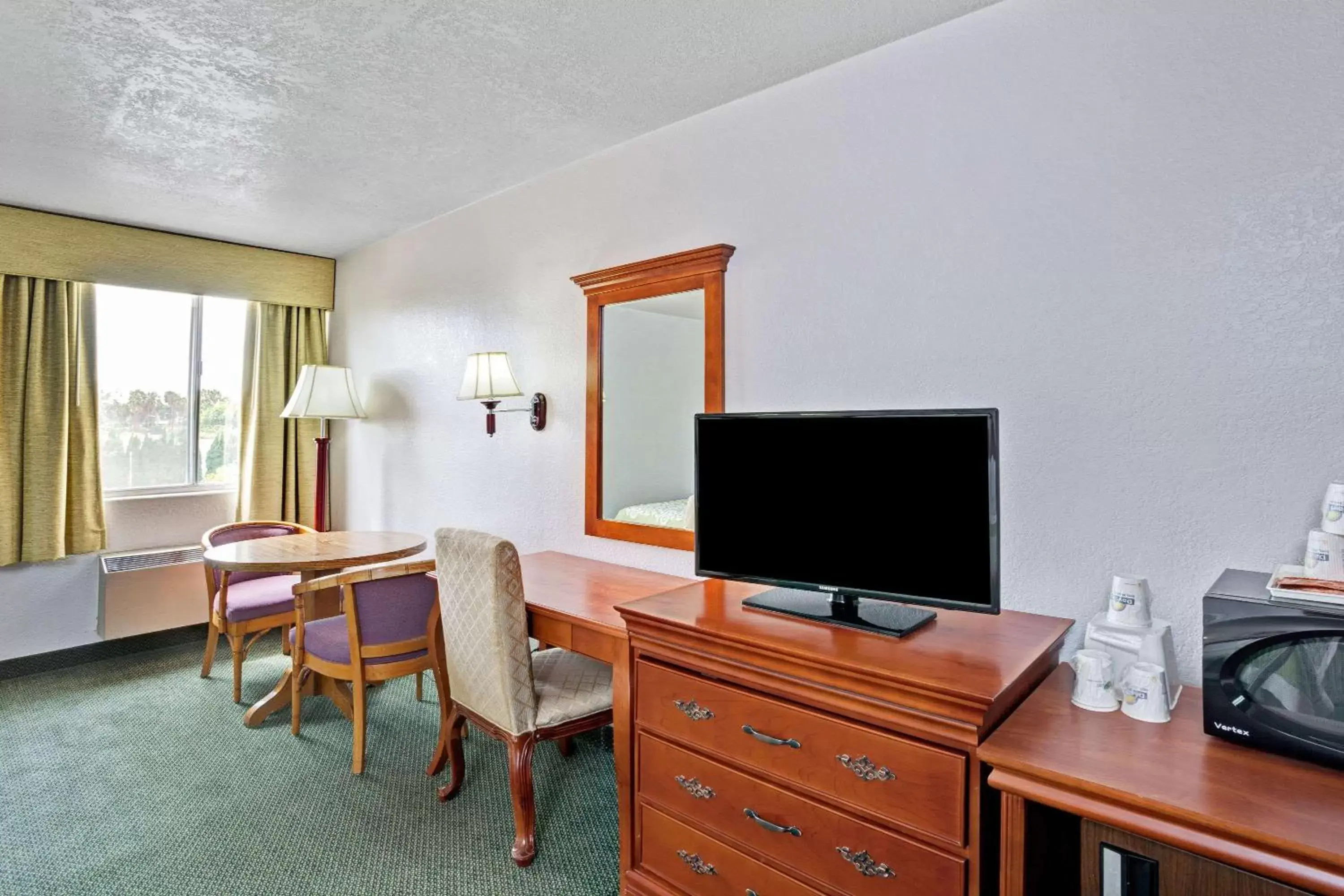 Photo of the whole room, TV/Entertainment Center in Days Inn & Suites by Wyndham Fullerton