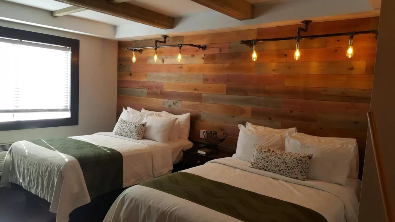 Bed in Cedar Stables Inn & Suites