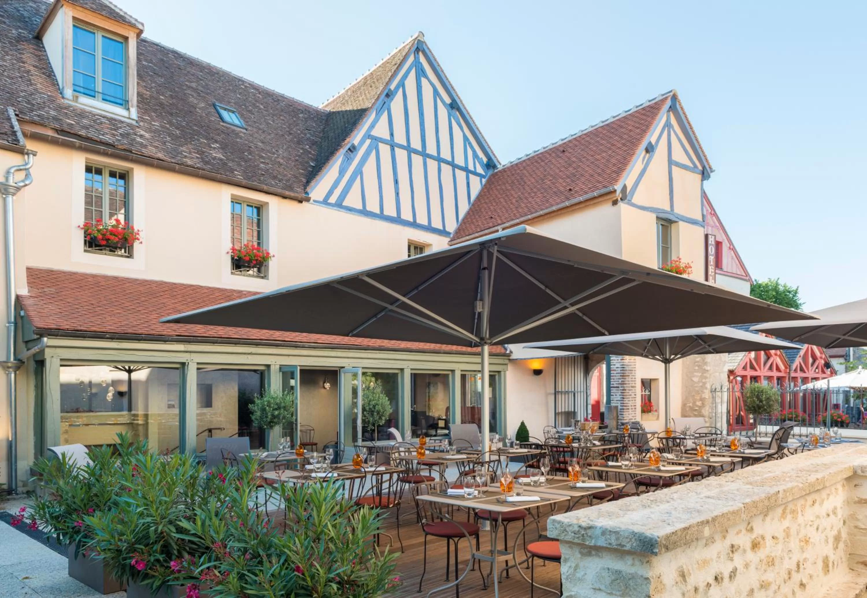 Patio in Hôtel Aux Vieux Remparts, The Originals Relais