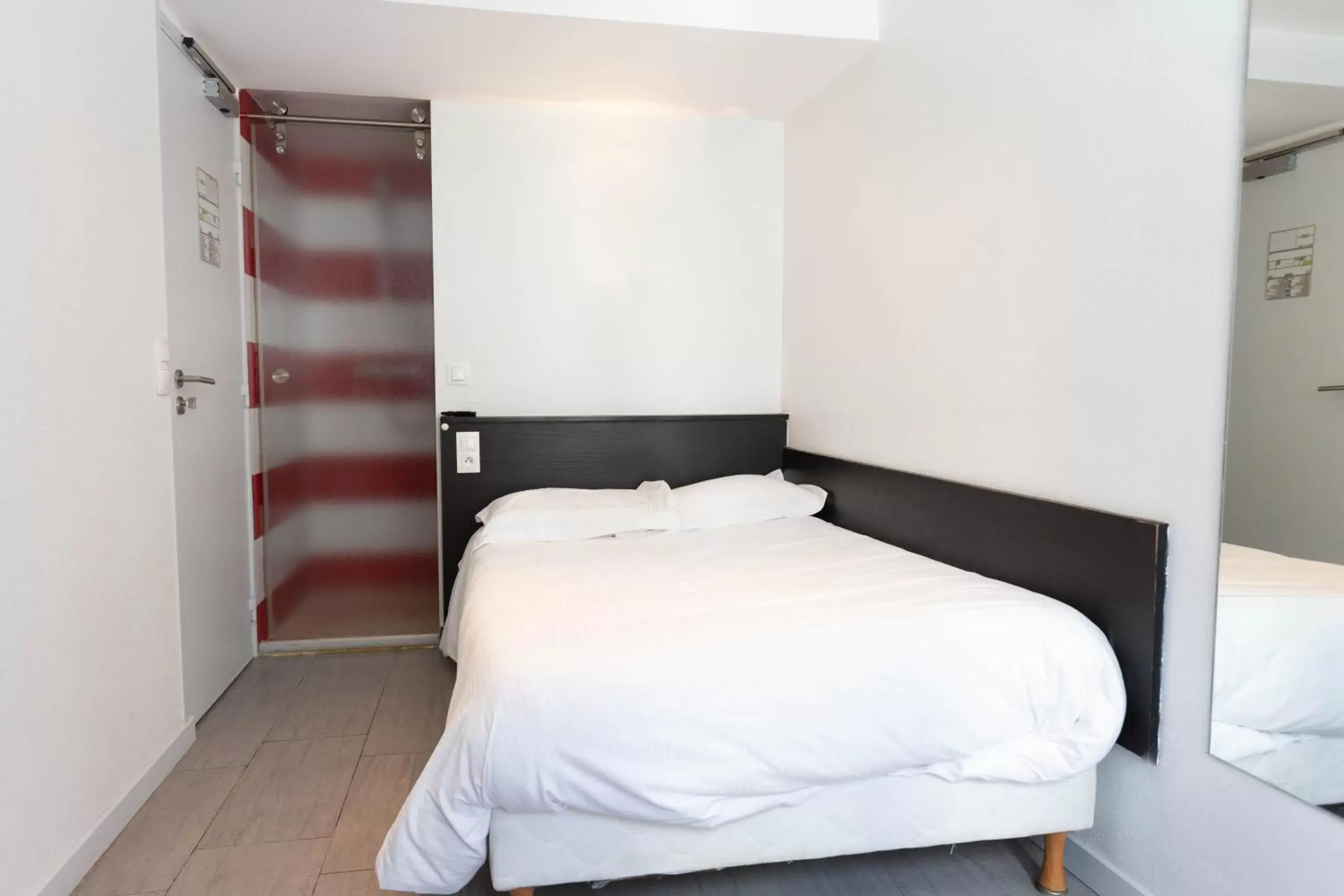 Bed in Hotel Mimosa Paris