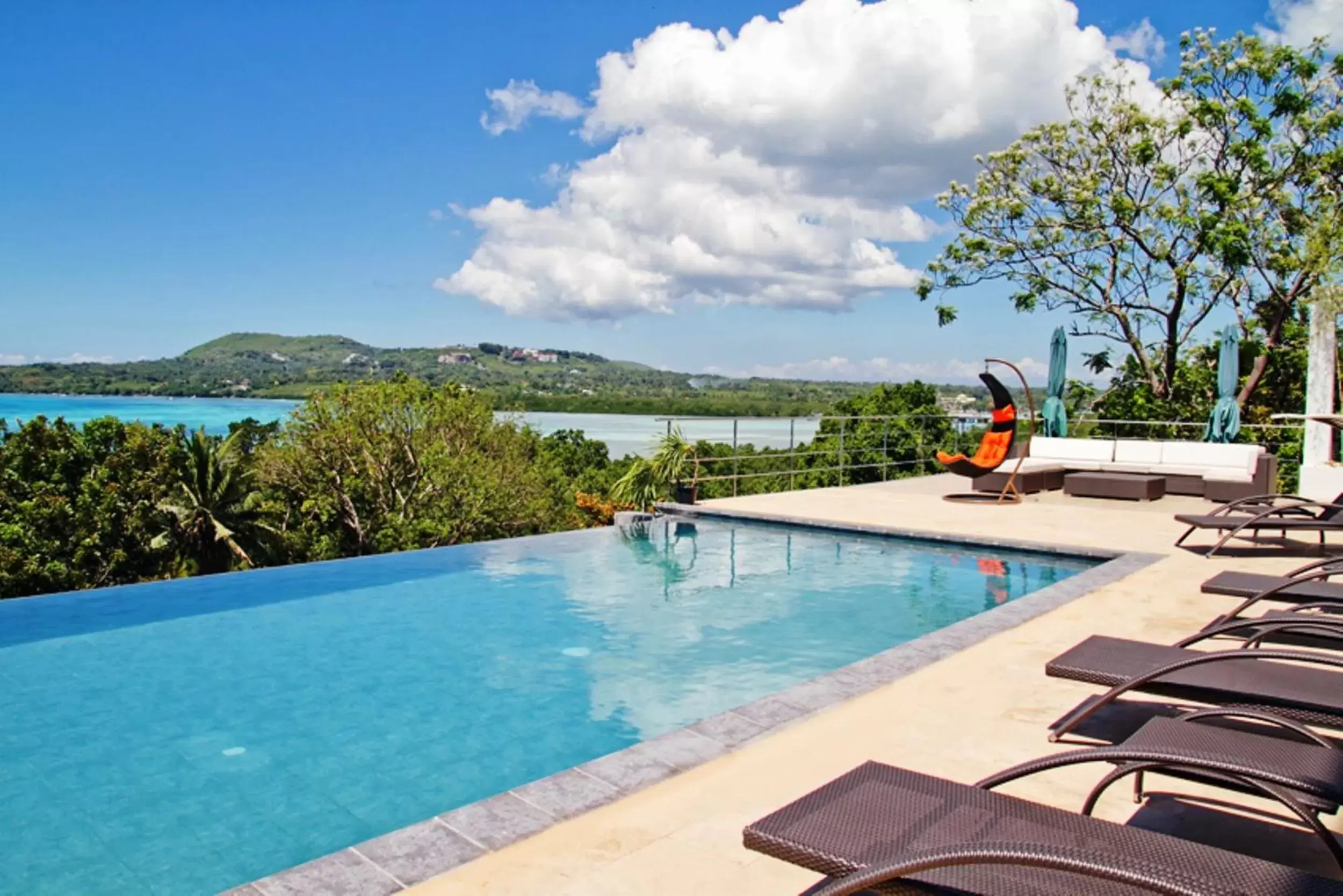 Bed, Swimming Pool in Ocean Suites Bohol Boutique Hotel