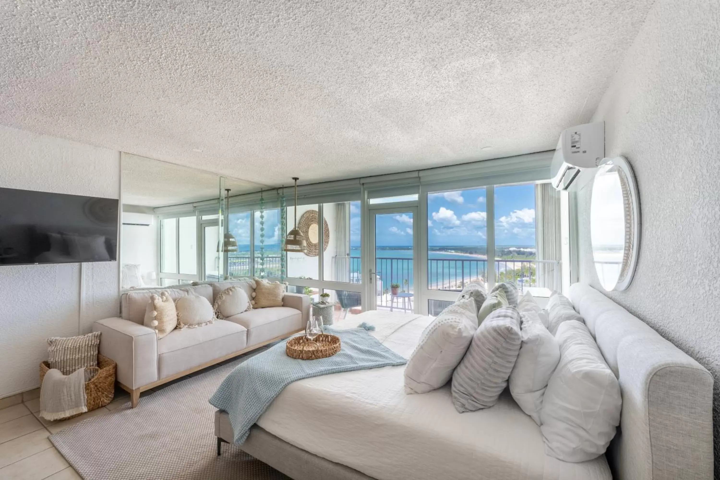 Bed, Seating Area in OCEAN VIEW DELUXE SUITE: PVT. BEACH & POOL