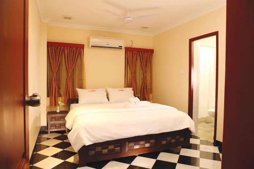 Bed in Meenakshi's Sunshine Hotel