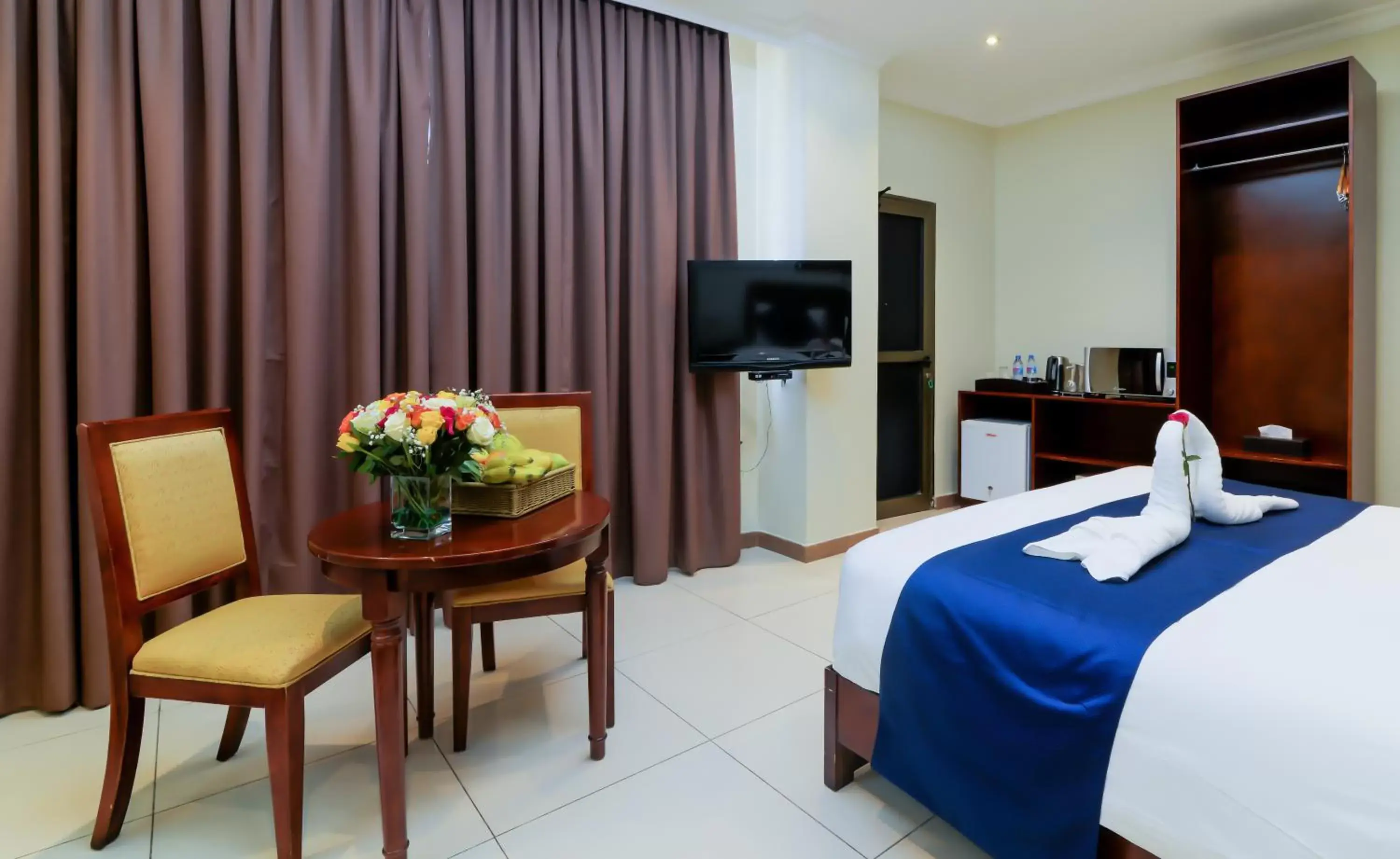 Bedroom, TV/Entertainment Center in Tanzanite Executive Suites