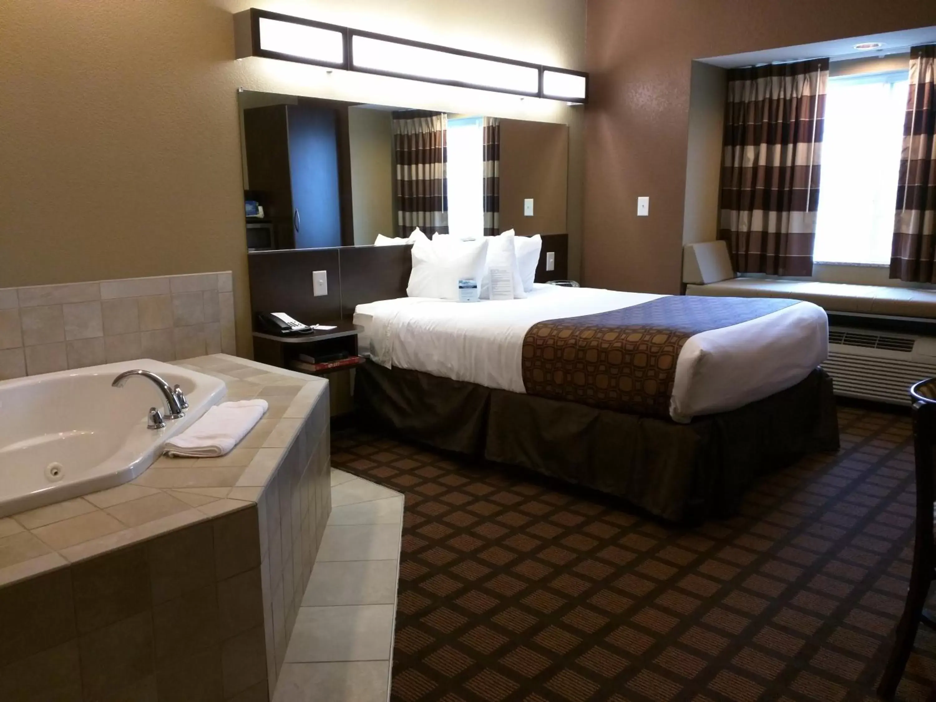 Bed, Bathroom in Microtel Inn & Suites by Wyndham Minot