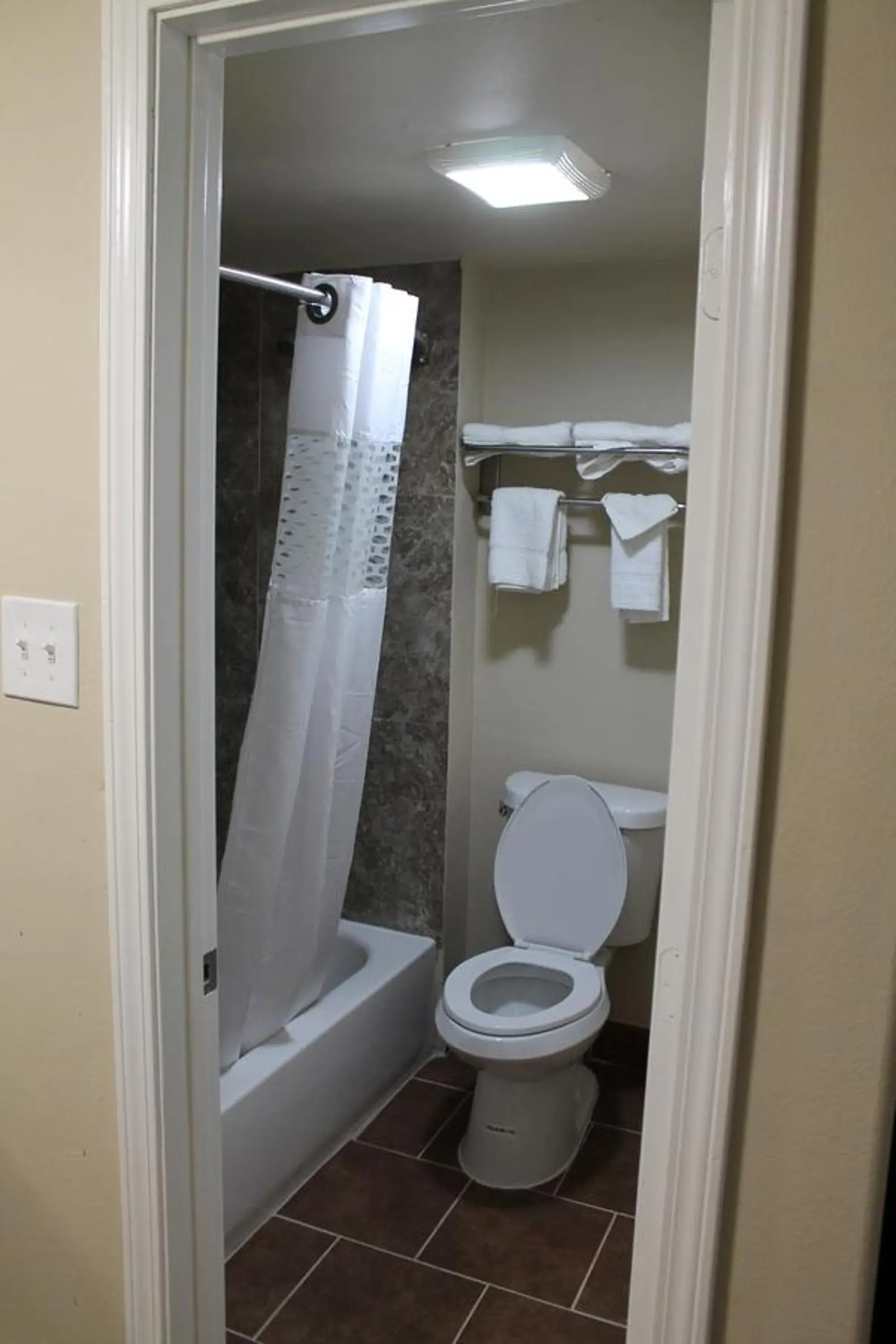 Toilet, Bathroom in American Inn & Suites